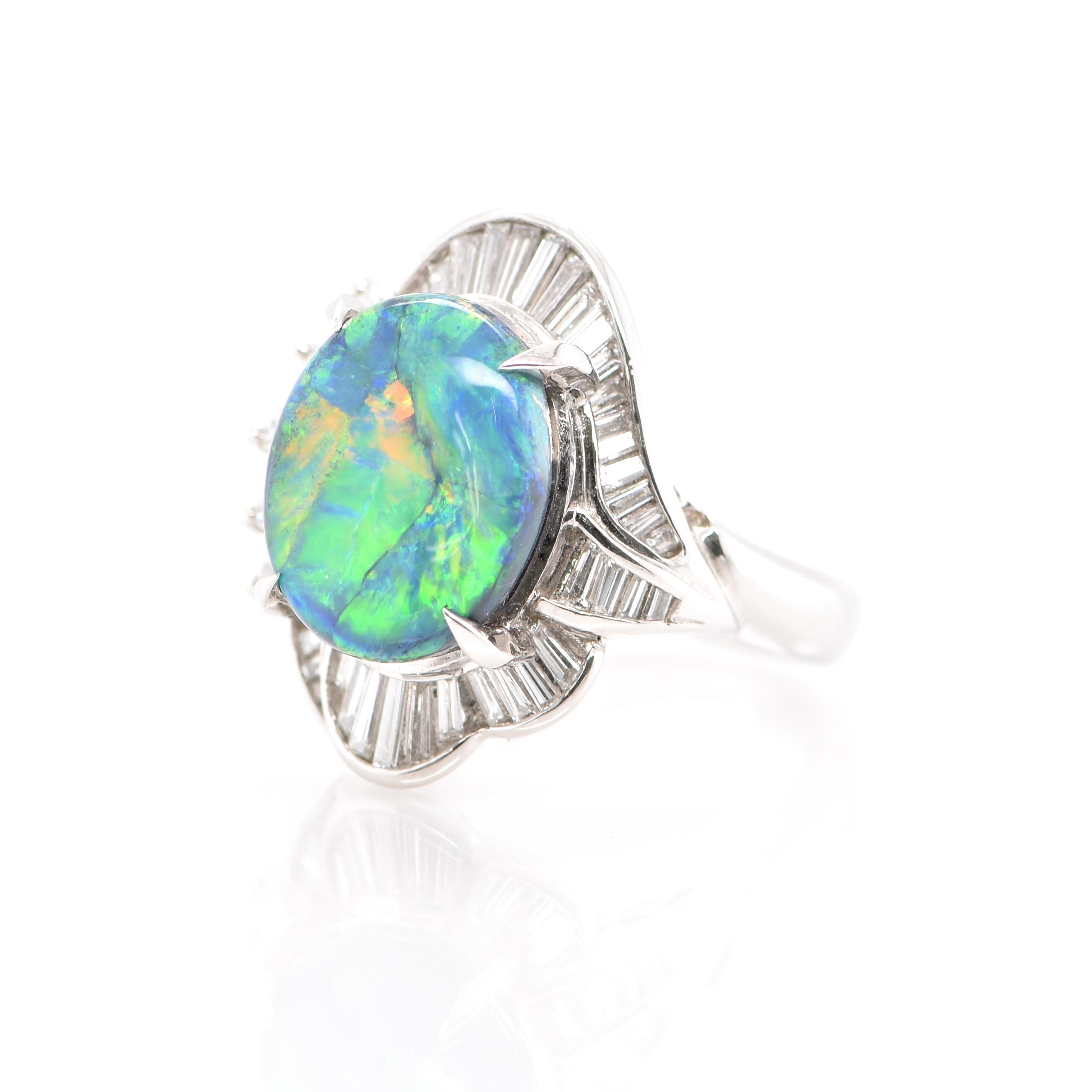 A beautiful Ballerina Cocktail Ring featuring a 4.93 Carat Australian Black Opal and 0.95 Carats of Diamond Accents set in Platinum. Opals are known for exhibiting flashes of rainbow colors known as 