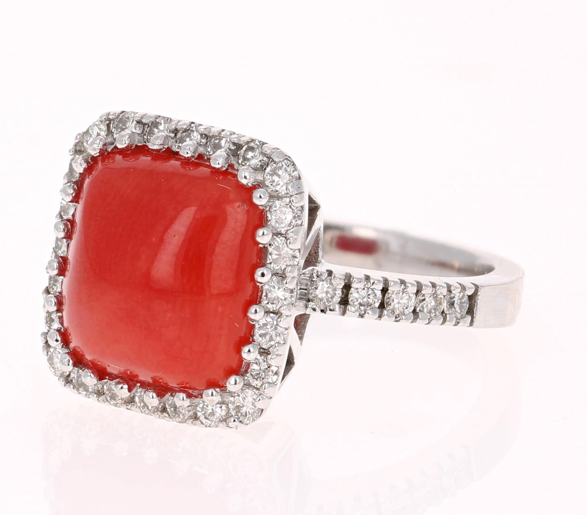 This exquisite Coral Ring is sure to be a stopper at any occasion! The Coral weighs 4.20  Carats and is adorned by 34 Round Cut White Diamonds weighing 0.73 Carats (Clairyt: VS2, Color: H)  The Total Carat Weight of this beauty is 4.93 Carats. 
It