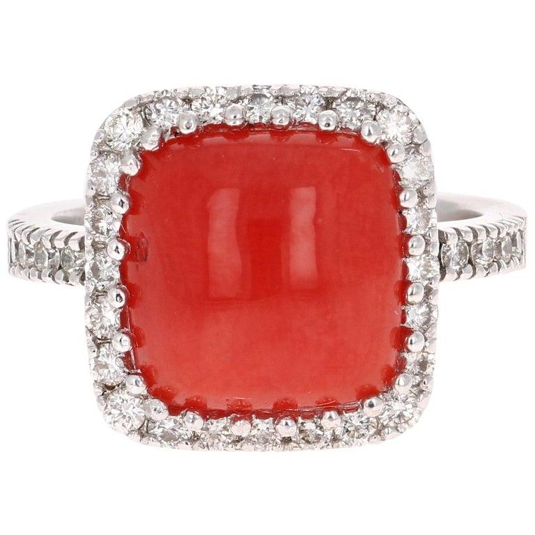 The Coral weighs 4.20  Carats and is adorned by 34 Round Cut White Diamonds weighing 0.73 Carats (Clairyt: VS2, Color: H)  The Total Carat Weight of this beauty is 4.93 Carats. The Coral measures at approximately 11 mm x 11 mm.

Crafted in 14K White