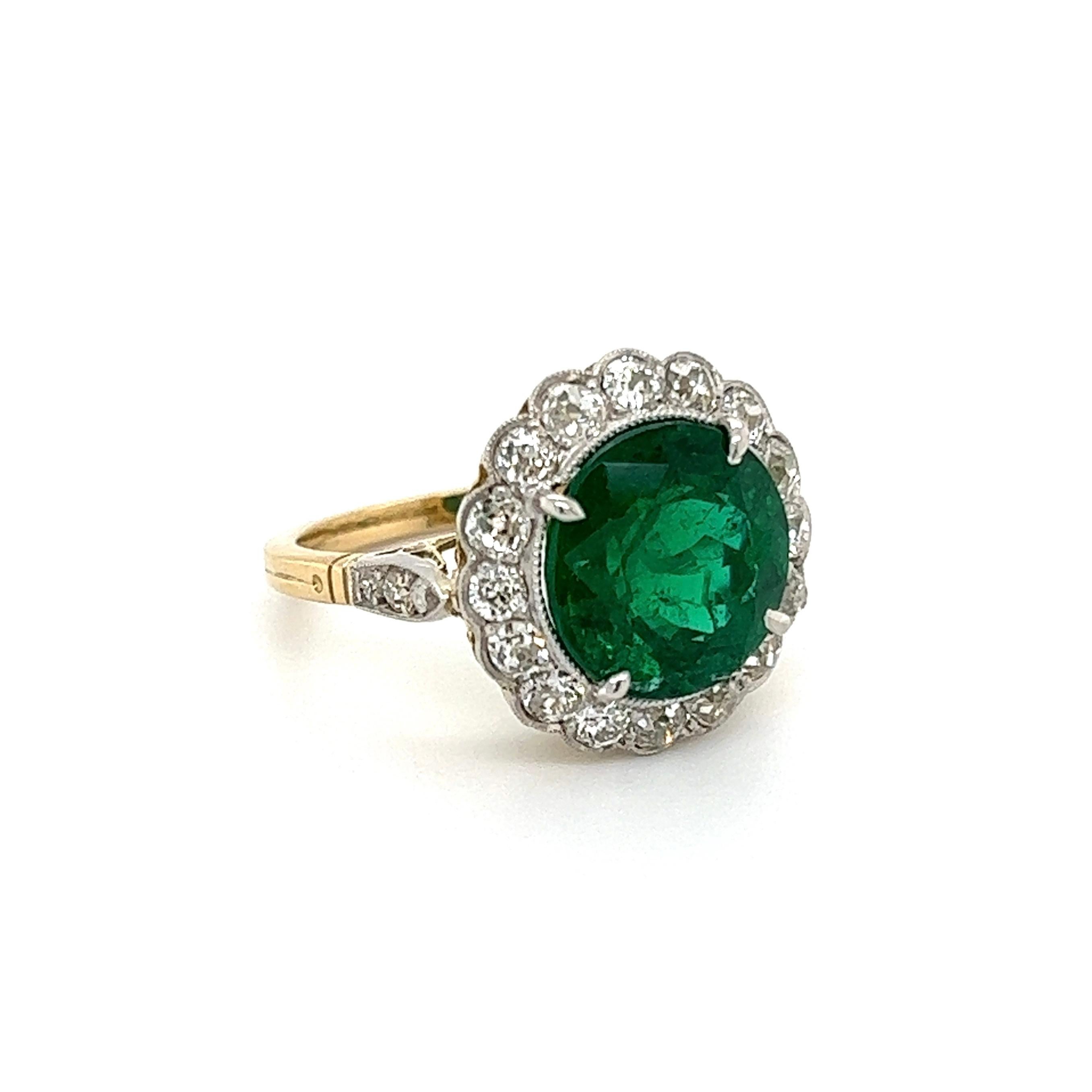 Simply Beautiful! Finely detailed Emerald and Diamond Platinum Cocktail Ring. Centering a securely nestled Round Emerald, weighing approx. 4.93 Carat, surrounded by Diamonds and including side Diamonds enhancing the shank, weighing approx. 1.30tcw.