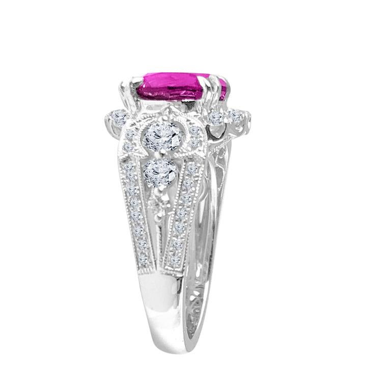 This exquisite ring features a central 4.93 carat round-cut Raspberry Garnet, elegantly encircled by a halo of round white diamonds. On each side of the shank, you'll find three substantial round diamonds, accompanied by additional smaller round