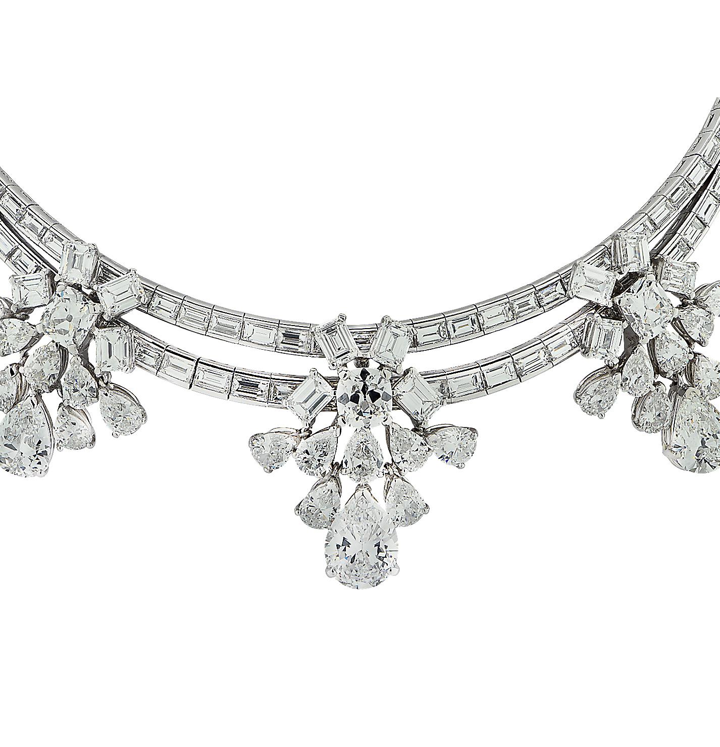 Exquisite diamond cluster necklace crafted in platinum showcasing 153 mixed cut diamonds weighing approximately 49.36 carats total D-H color, VVS-SI clarity. Baguette cut diamonds adorned with three dazzling diamond cluster motifs swirl around the