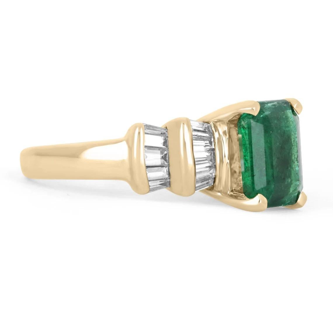 Featured is a stunning emerald and diamond ring. The center stone carries a gorgeous 3.03-carat, natural emerald; displaying a dark green color and very good luster. Minor imperfections can be seen, but are natural in earth-mined gems. An array of