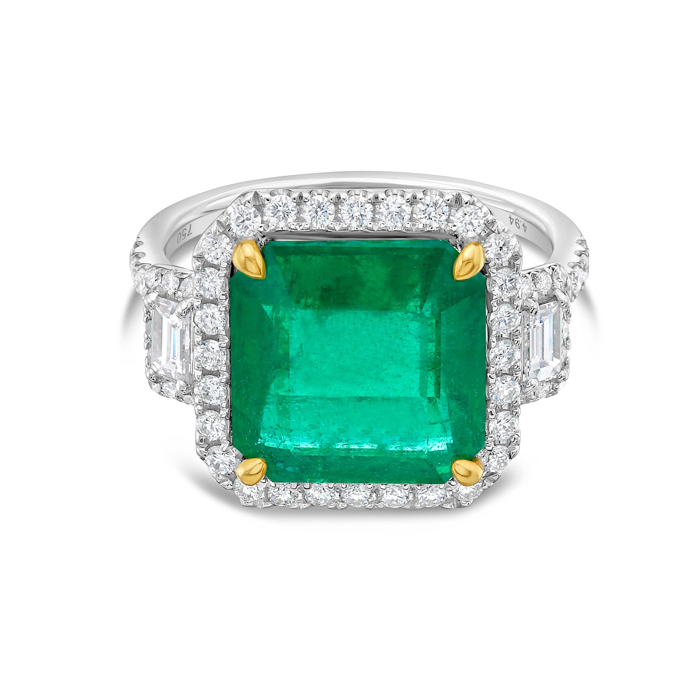 This stunning Cocktail Ring features a beautiful 4.94 Carat Emerald Cut Emerald with a Diamond Halo, that sits on a Diamond Shank. The Emerald is flanked by two stunning Baguette Cut White Diamond Side Stones. 

This Ring is set in 18K White Gold,