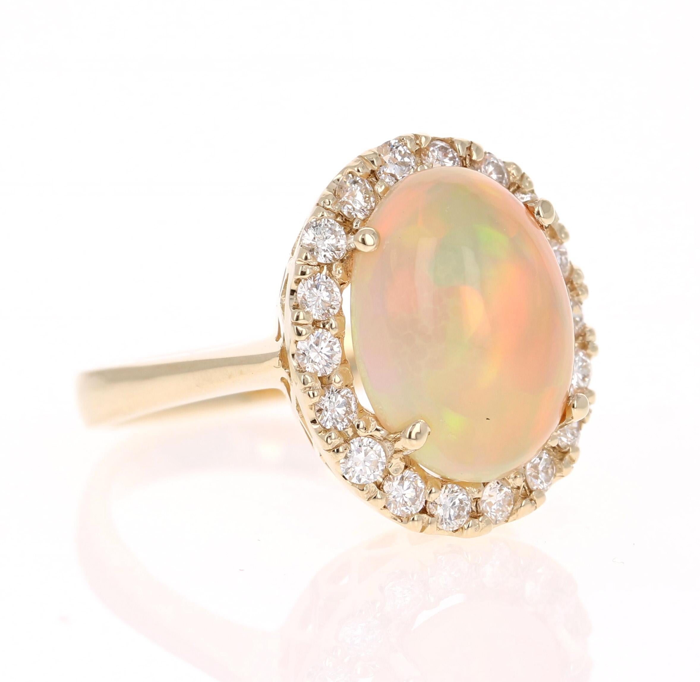 Simply beautiful Opal and Diamond 14 Karat Yellow Gold Ring. 

This ring has a lovely Oval Cut Ethiopian-Origin Opal that weighs 4.35 Carats and has flashes of orange, green, red and yellow shining bright. There are 18 Round Cut Diamonds that weigh