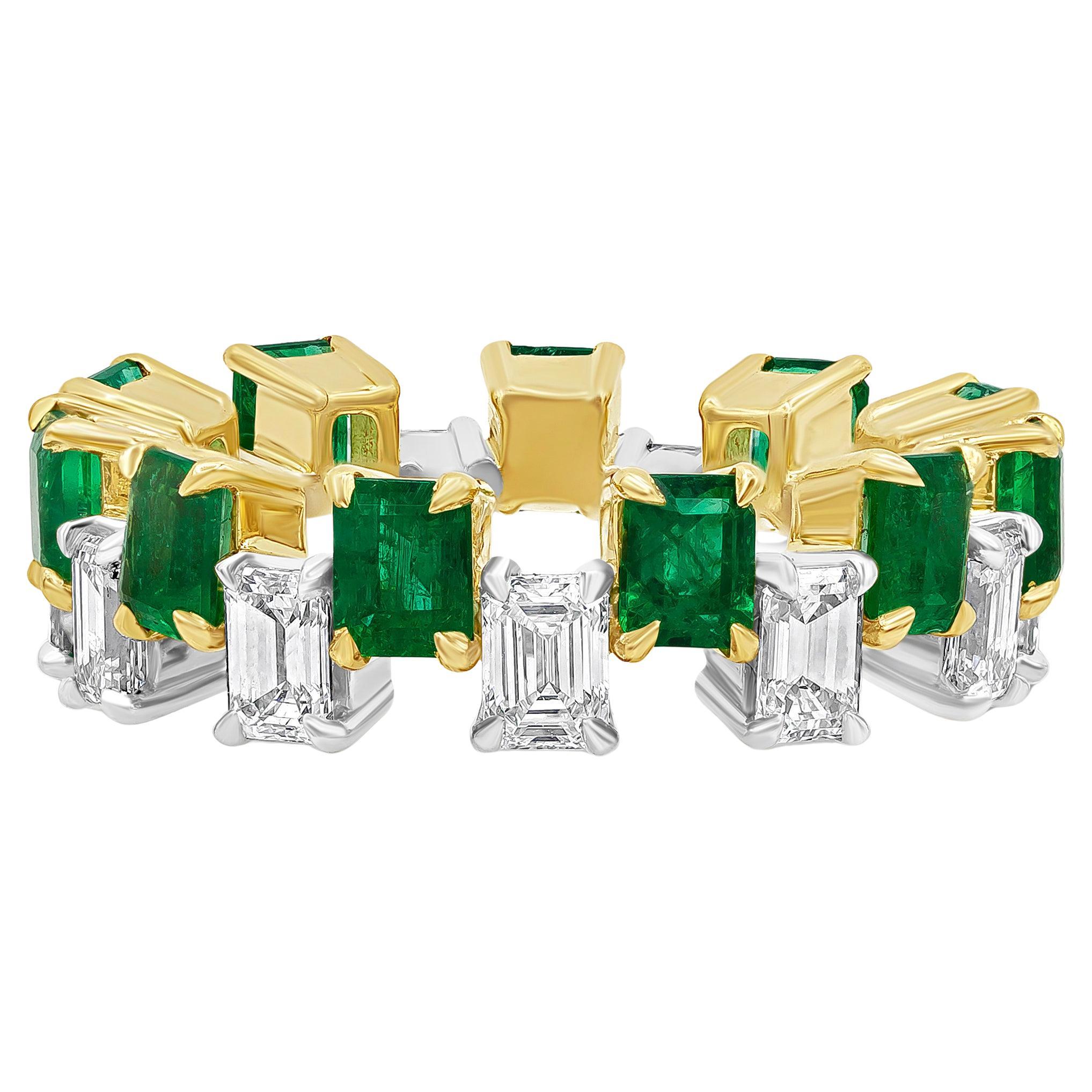 A uniquely-designed ring showcasing emerald cut green emeralds that elegantly alternate with emerald cut diamonds. Green emeralds weigh 2.67 carats total while diamonds weigh 2.27 carats total and are approximately G color, VS in clarity. Perfectly