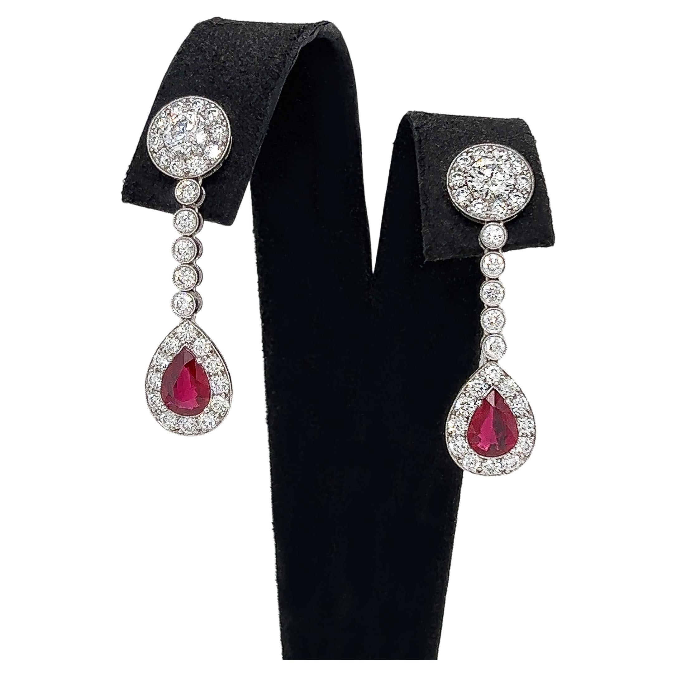4.94 Total Carat Ruby and Diamond Drop Earrings in Platinum

This gorgeous pair of Ruby earrings are sure to draw all eyes on you. It is created with generous 1.82 Carats worth of Pear cut rubies, surrounded by a halo and drop of round cut pave set