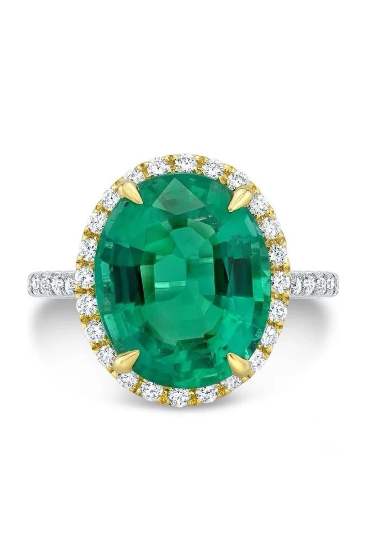 18K white and yellow gold ring, featuring an enticing 4.94-carat, oval Zambian Emerald accented by 40 shimmering white diamonds totaling 0.43 cts. This Zambian Emerald is GIA certified.