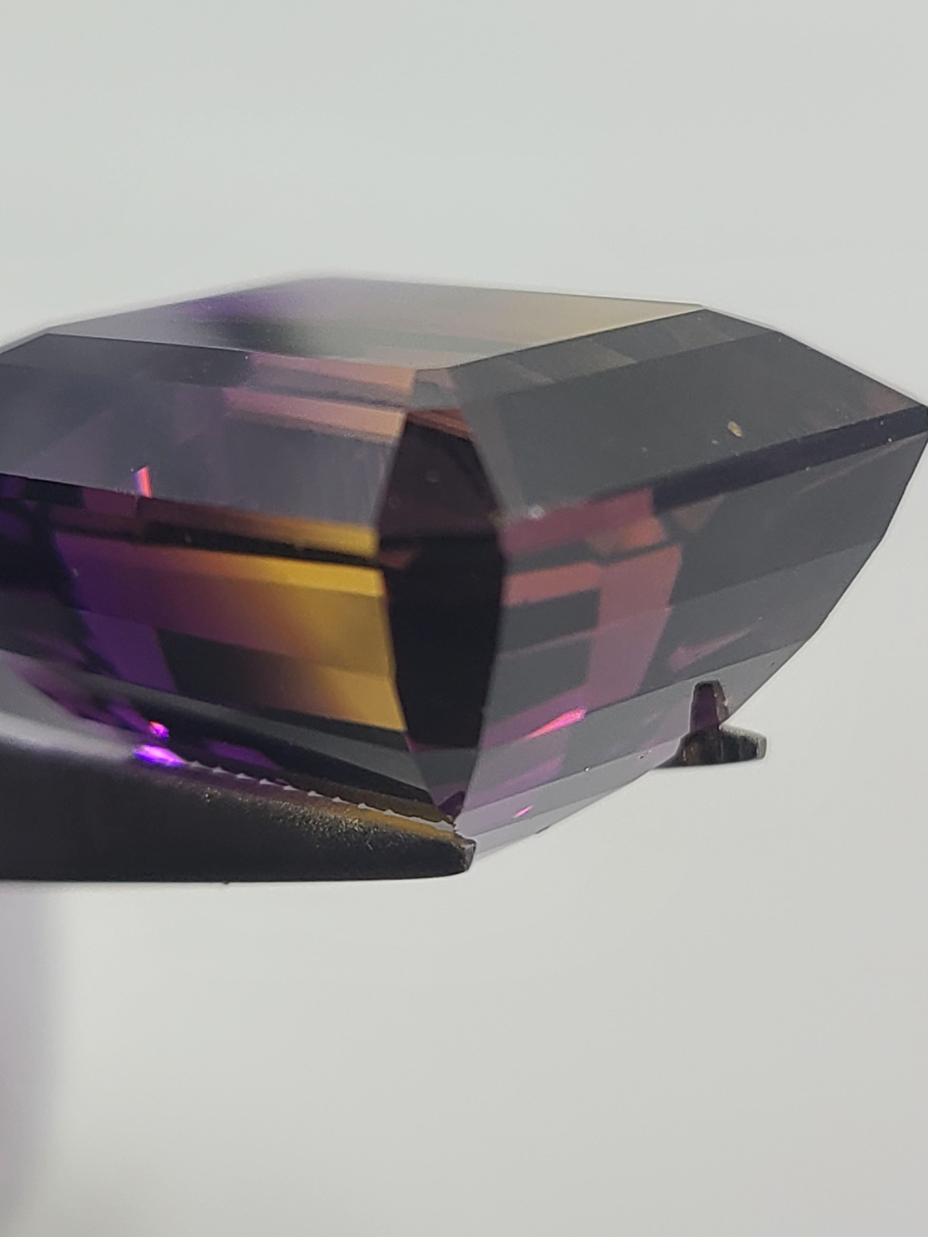 Dieser EXTRA GROSSE Ametrin im Smaragdschliff (rechteckiger Stufenschliff) zeigt seine charakteristische Zweifarbigkeit, bei der ein kräftiges Violett (Amethyst) in ein Sonnengelb (Citrin) übergeht.  Ein Muss für alle, die Quarz lieben!

Dieser