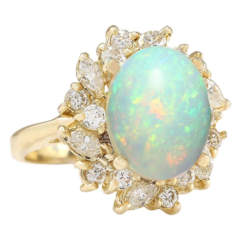 Stamped: 18K Yellow Gold
Total Ring Weight: 7.6 Grams
Ring Length: N/A
Ring Width: N/A
Gemstone Weight: Total Natural Opal Weight is 3.45 Carat (Measures: 13.25x10.50 mm)
Color: Multicolor
Diamond Weight: Total Natural Diamond Weight is 1.50
