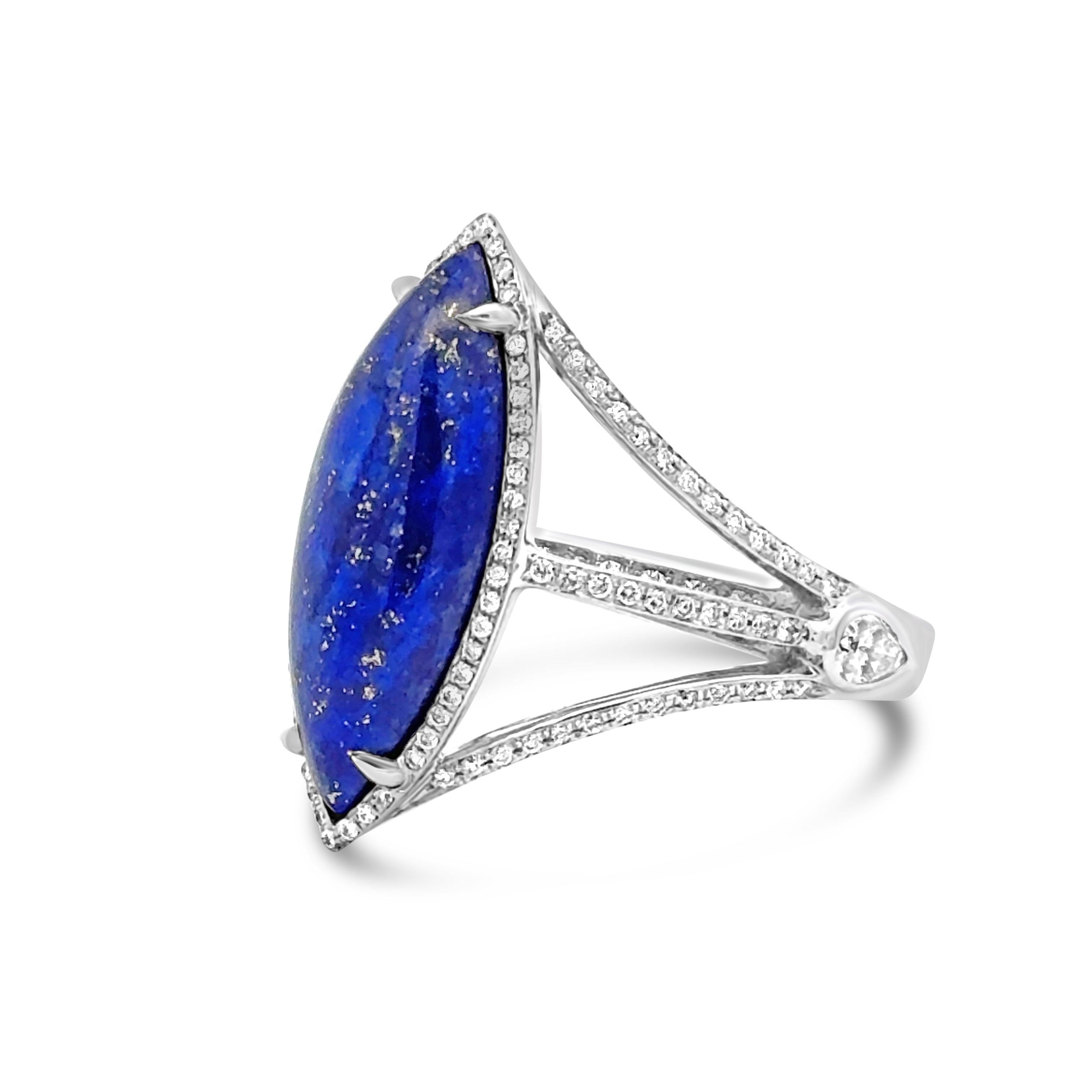 A stylish fashion ring, featuring a 4.95 carats marquise cut lapis lazuli surrounded by a halo of round cut diamonds weighing 0.56 carat total. Accented by pear shape diamonds on both ends. Finely made with 18K white gold. Size 6.5 US, resizable
