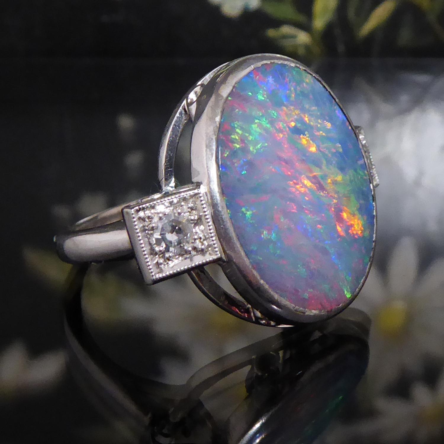 A beautiful large boulder opal and diamond ring which we have repurposed from a bar brooch to a ring, although we do believe it started life as a ring before being remade into a brooch!

The opal is a cabochon cut, solid boulder opal measuring