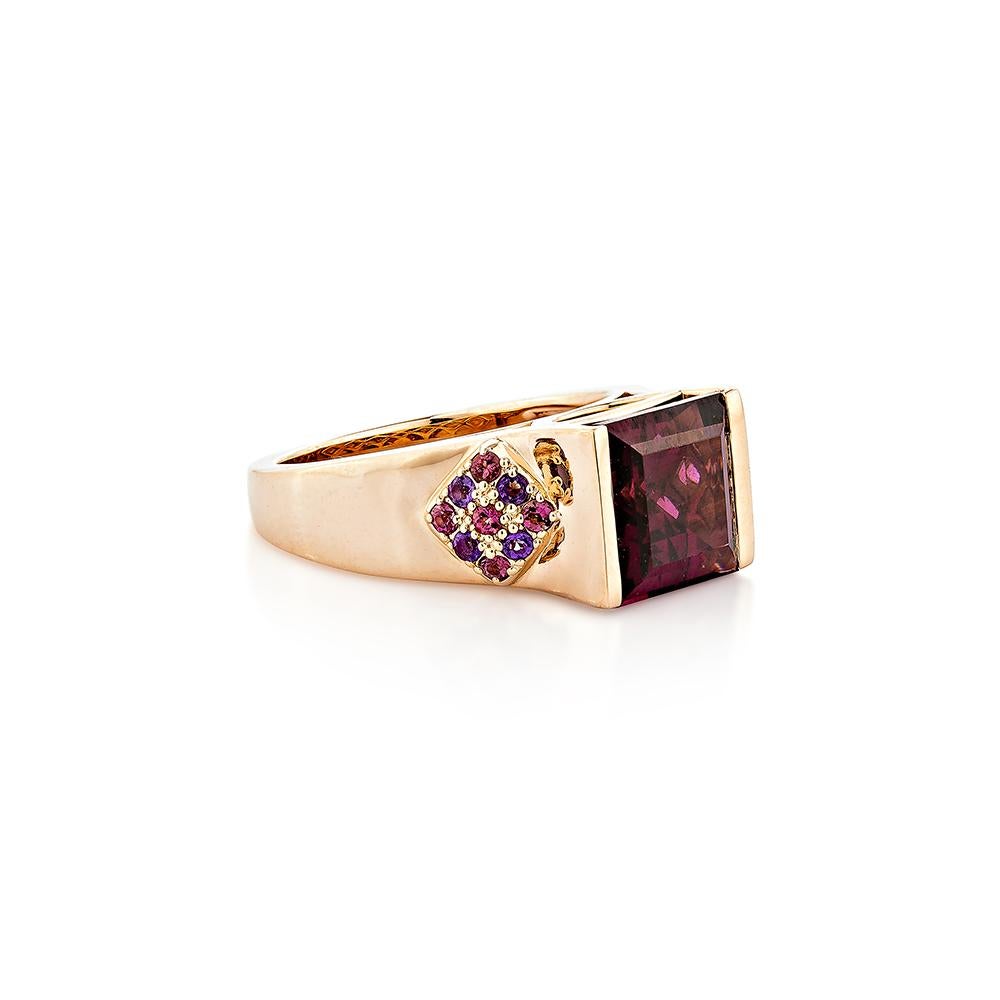 This timeless, elegant rhodolite ring in the shape of a princess, set with amethyst and pink tourmaline, may be worn on a daily basis as well as for special occasions. This ring is made of rose gold and is pretty lovely.
  
Rhodolite Fancy Ring in