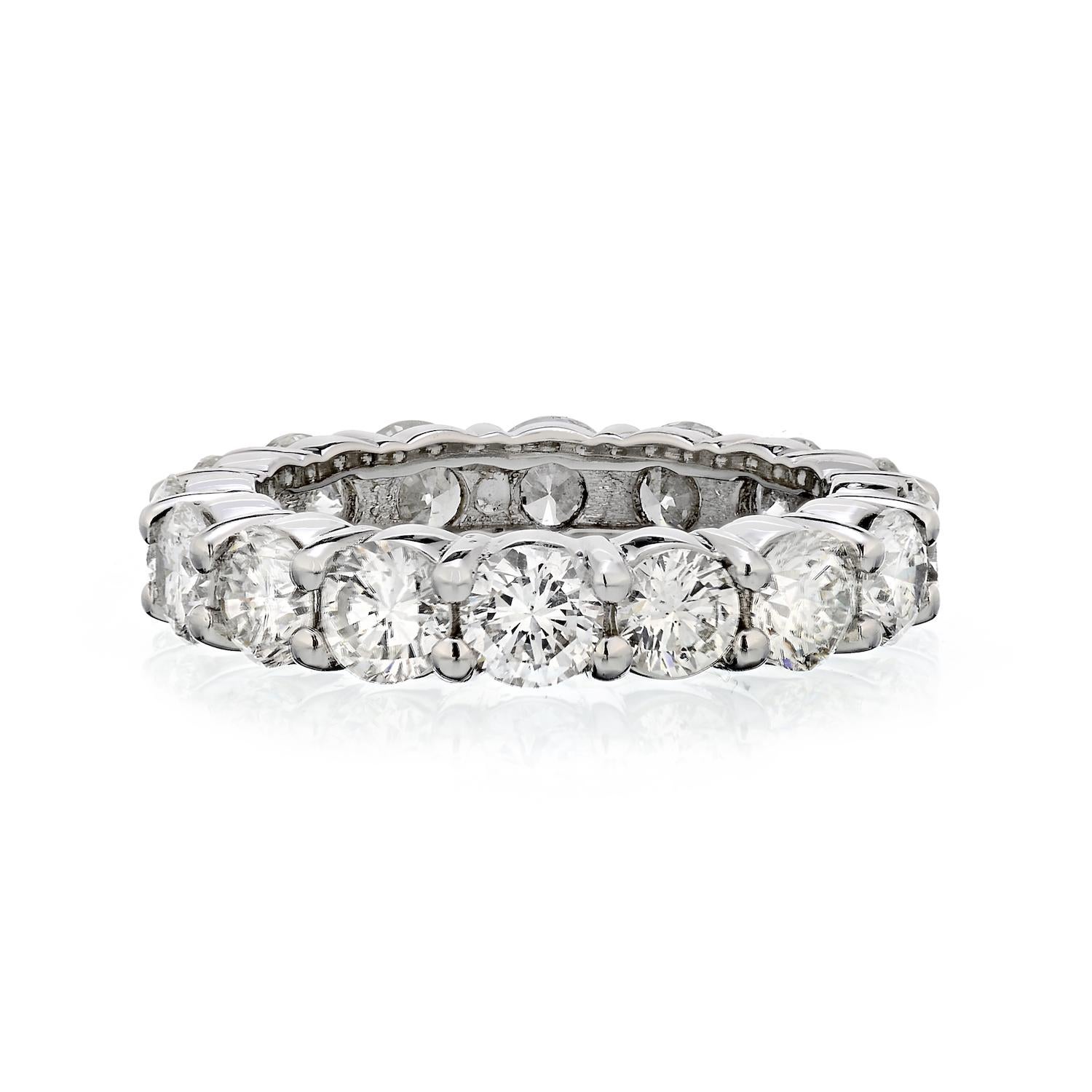 Custom made shared prong diamond eternity band crafted in Platinum set with round brilliant cut diamonds. Total carat weight of 4.96 carats. 
Finger size 6.25. 