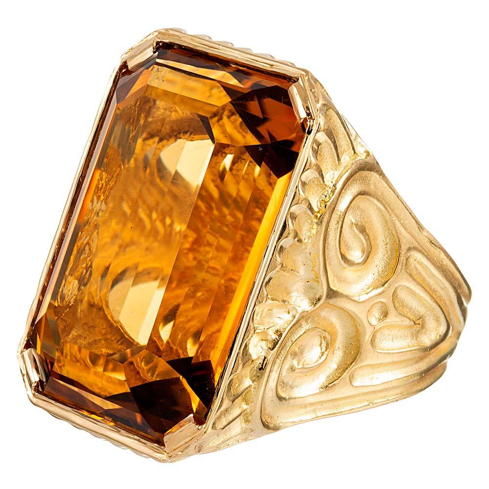 A unique scrolling design graces the sides of this generous ring, made of 18 karat yellow gold and handsomely appointed with a 49.64 carat emerald cut citrine. Suitable for a lady or gentleman, size 7 can be resized on request.
