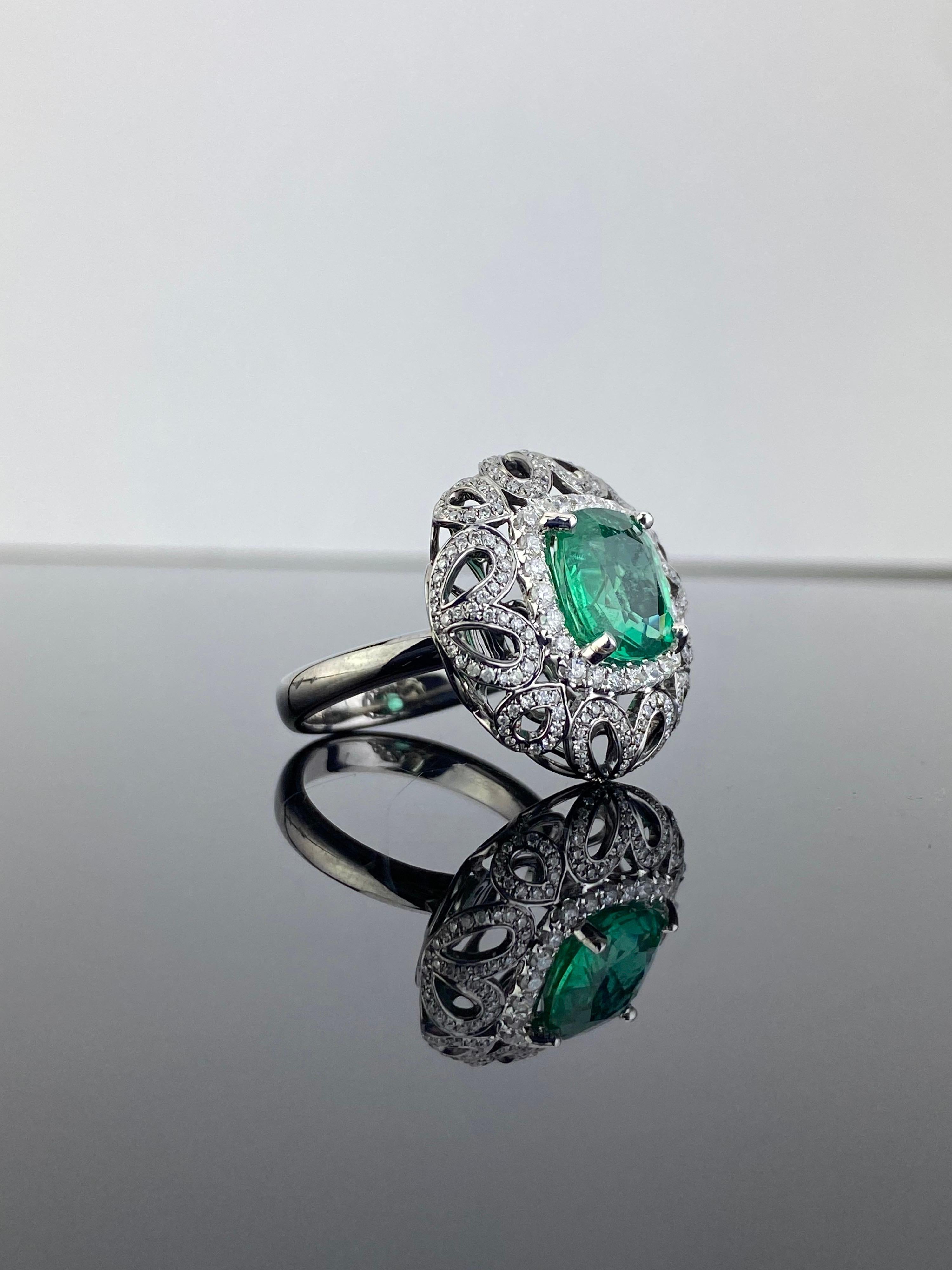 A beautiful 4.97 carat natural Zambian Emerald Cocktail ring, with Brilliant cut Diamond on 18K Gold Band. The Emerald centre stone is completely transparent with a brilliant luster. 
Currently sized at US 7, can be resized.

Center Stone Details: