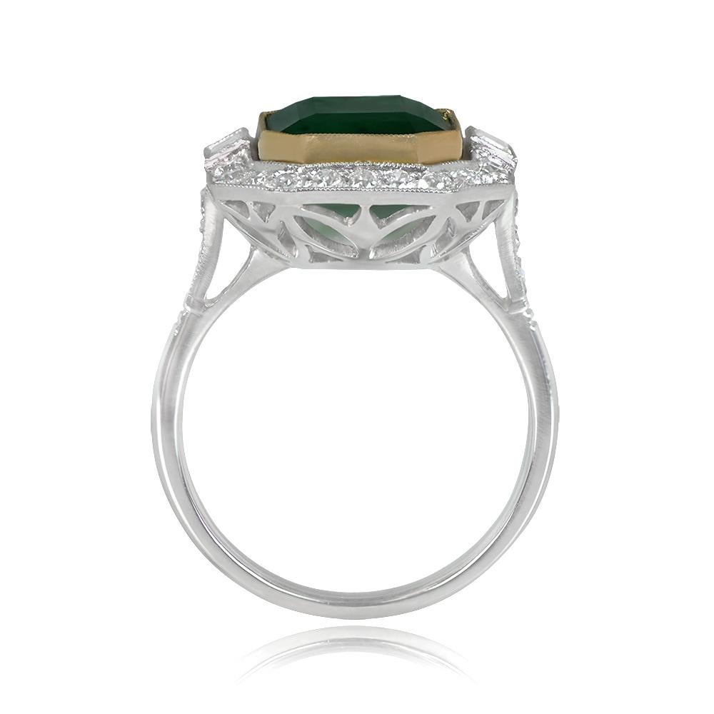 This exquisite ring showcases a 4.97-carat emerald-cut natural emerald elegantly bezel-set in 18k yellow gold. The center emerald is accented by two baguette-cut diamonds on each side and encircled by a captivating halo of old European cut diamonds.