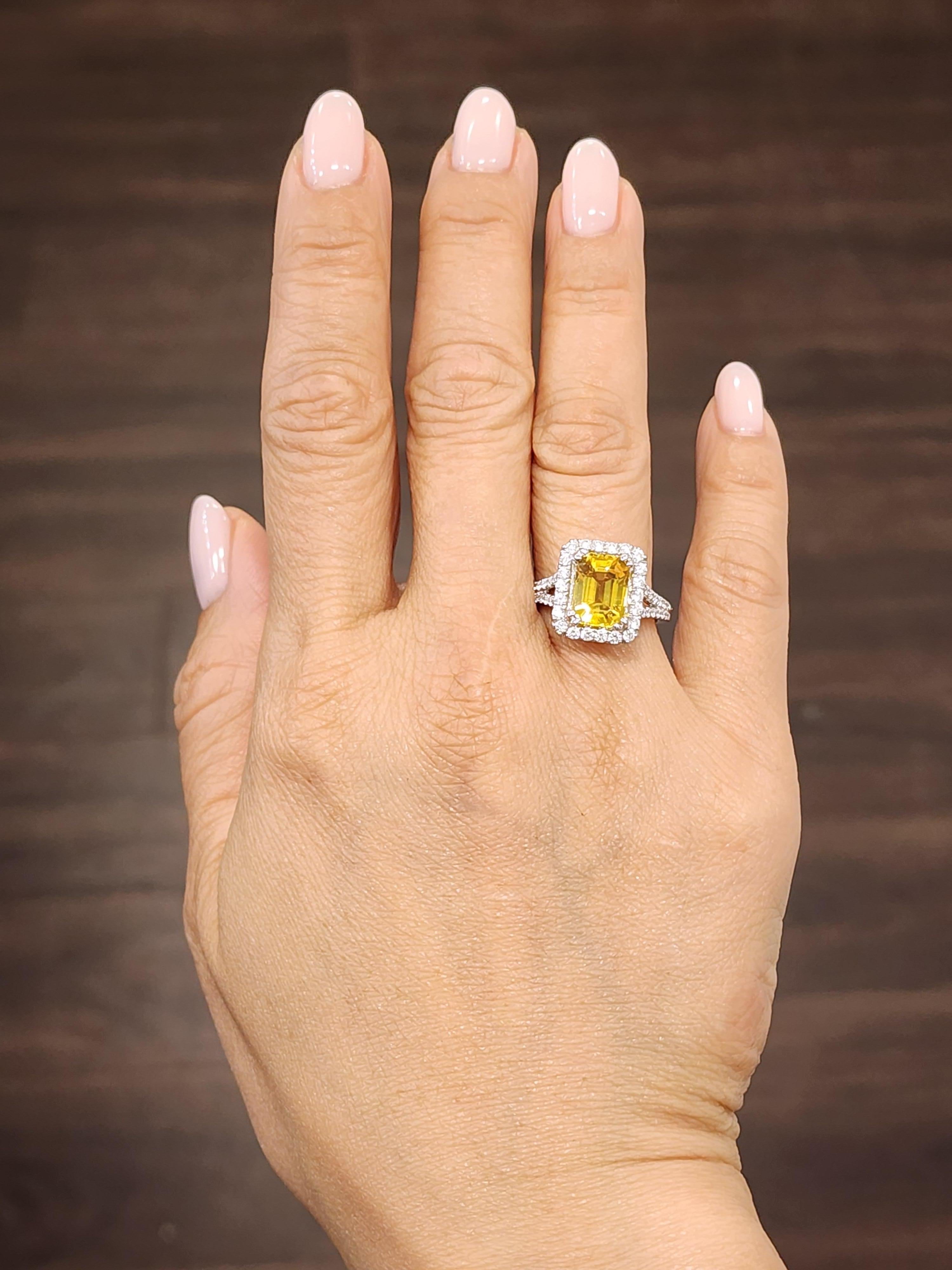 This stunning 18k white gold natural yellow sapphire and diamond ring weighs 4.98 ct. The ring features an emerald cut natural yellow sapphire weighing 3.78 ct. and 100 round diamonds weighing 1.20 ct. A definite head turner to any wardrobe!