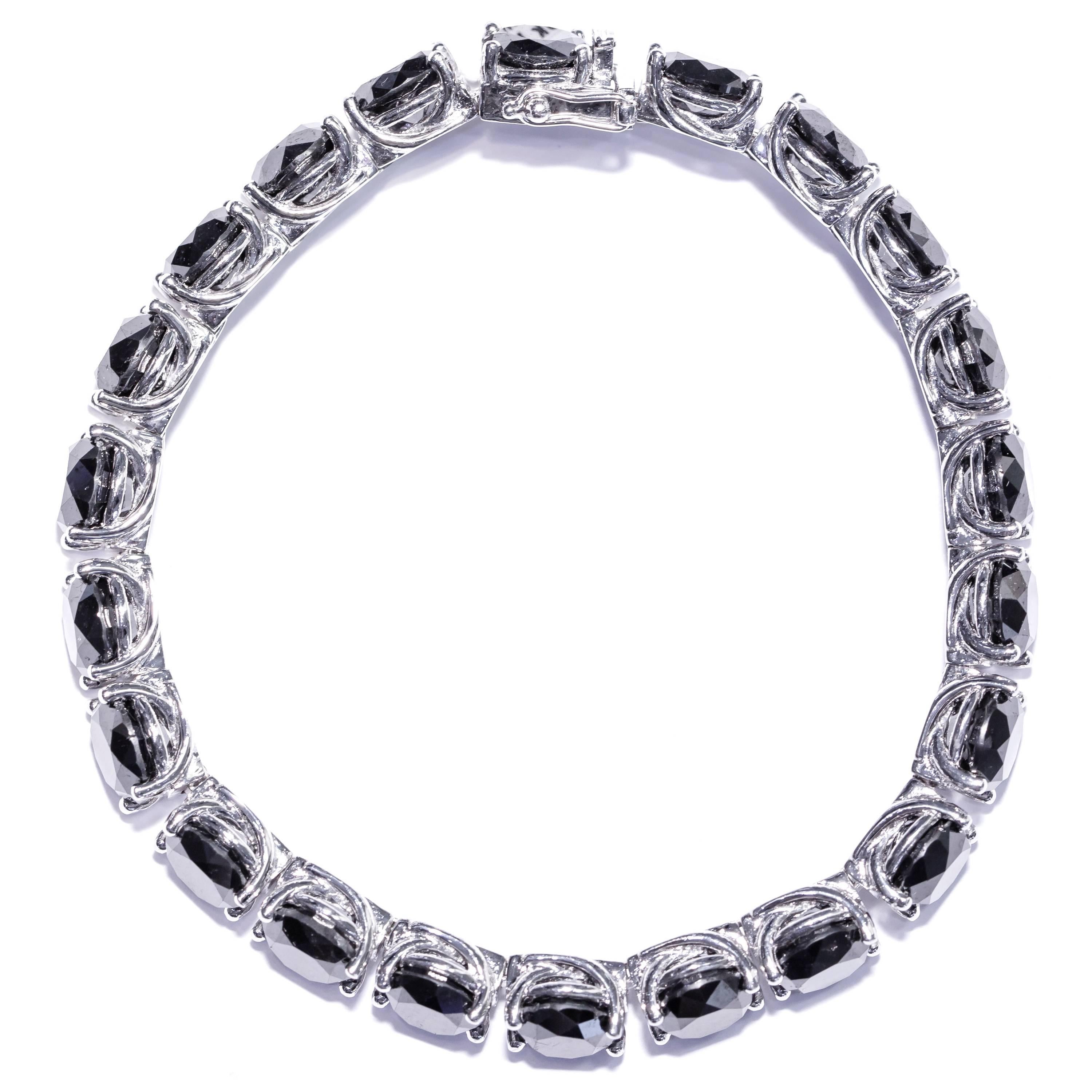 This stunning Black Diamond classic tennis bracelet features 22 stones weighing 49.68 Carats. This 18 Karat bracelet has a safety lock on the clasp, Total weight of the bracelet is 42 Grams, and is 7.5 inches long. Made by Tresor Paris this Bracelet