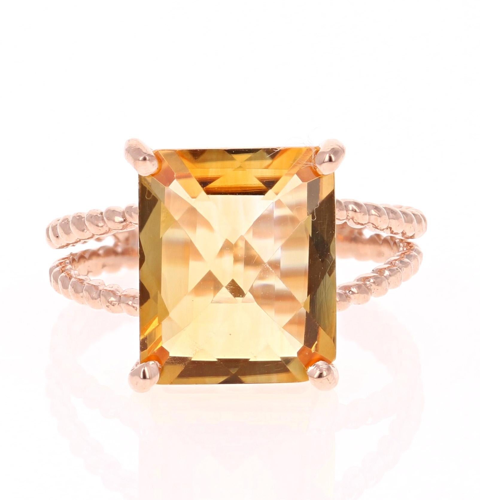 This beautiful and simple ring has a bright and vivid Emerald Cut Citrine Quartz in the center that weighs 4.99 carats. 
The setting is beautifully crafted in 14K Rose Gold and weighs approximately 3.2 grams.
The ring is a size 7 and can be re-sized