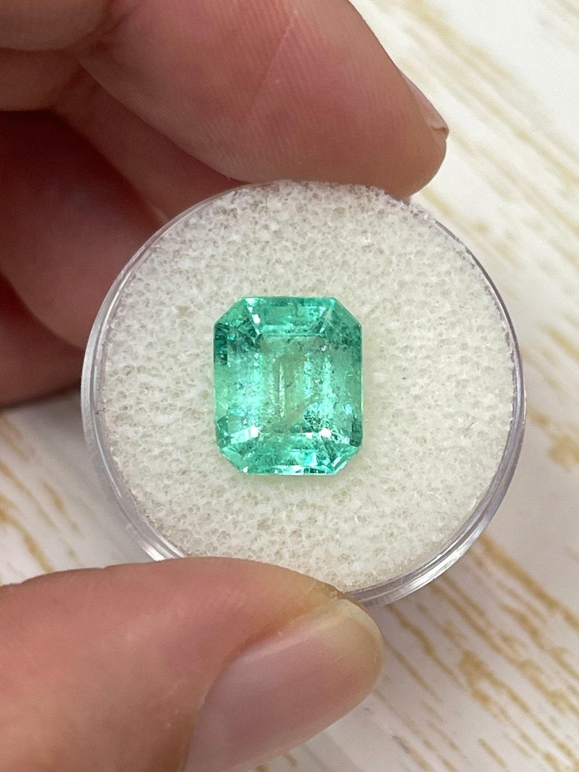 Stone: Emerald
Weight: 4.99-carats
Shape: Emerald Cut
Clarity: Transparent
Luster: Very Good
Color: Minty Green
Measurements: 11.45mm x 9.59mm x 6.68mm
Geographic Origin: Colombia
Treatment: Natural, Oiling

Comments: Due to their growth conditions