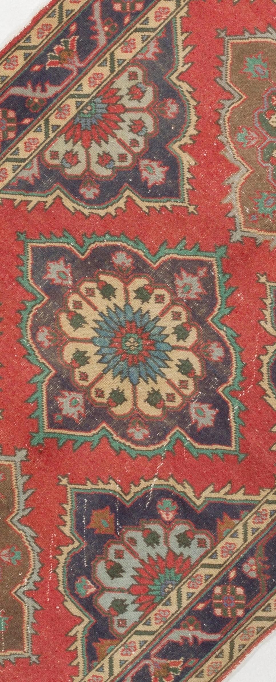 An early 20th century hand-knotted wool Turkish runner rug with soft wool pile on cotton foundation. It features a multiple medallion design in red, indigo, beige and green.
Very good condition. Sturdy and as clean as a brand new rug (deep washed