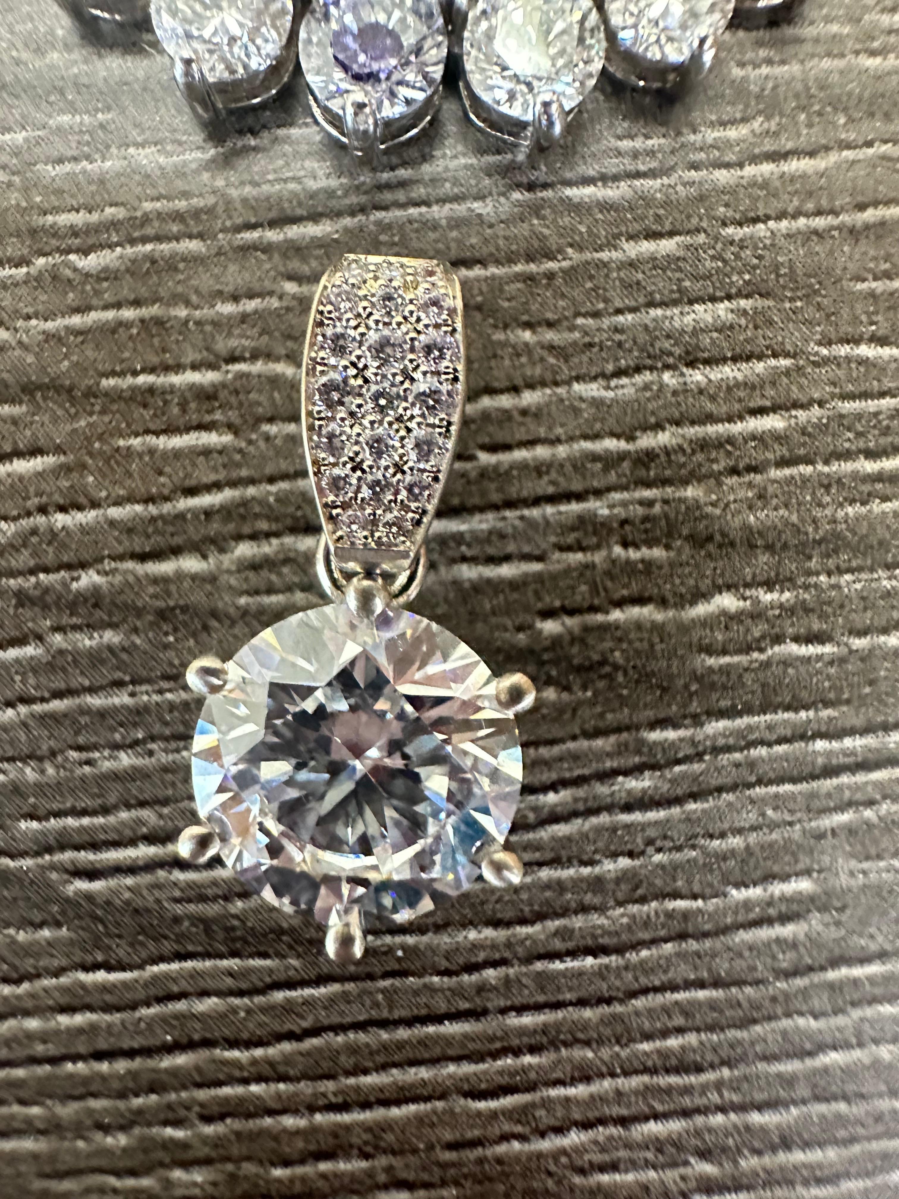 Stunning pendant can be worn on any strand of pearls on its own or on your existing favorite tennis necklace.
Metal Type: 18KT

Natural Diamond(s): 
Color: F-G
Cut:Round Brilliant
Carat: 0.40ct
Clarity: VS

Center diamond is SI2, G color totalling 4
