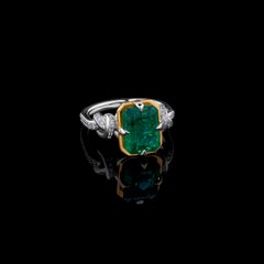4ct Emerald Cut Forget Me Knot Emerald ring in Platinum and 22k Yellow Gold