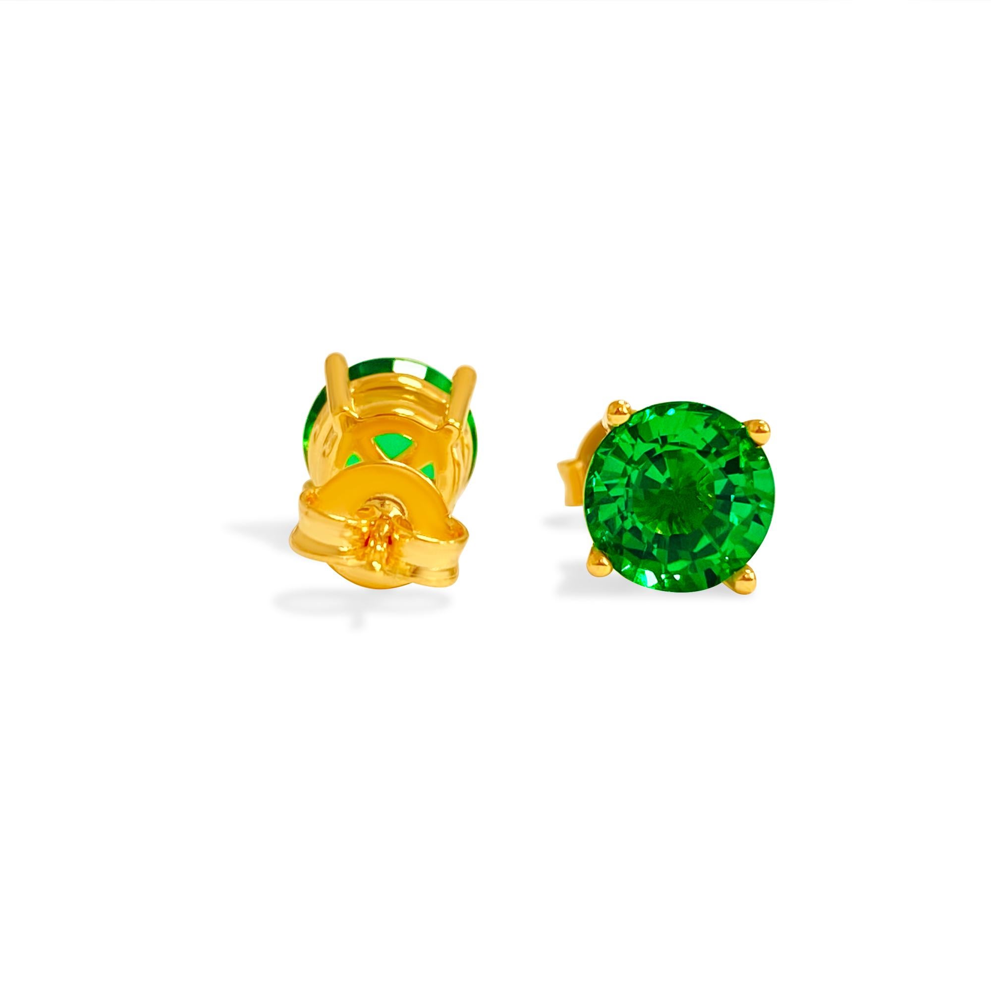 Made in radiant 14K yellow gold, these exquisite stud earrings feature lab-made emeralds with a total carat weight of 4cts, showcasing a flawless round shape and classic four-prong setting for timeless elegance. Each emerald boasts a gorgeous even