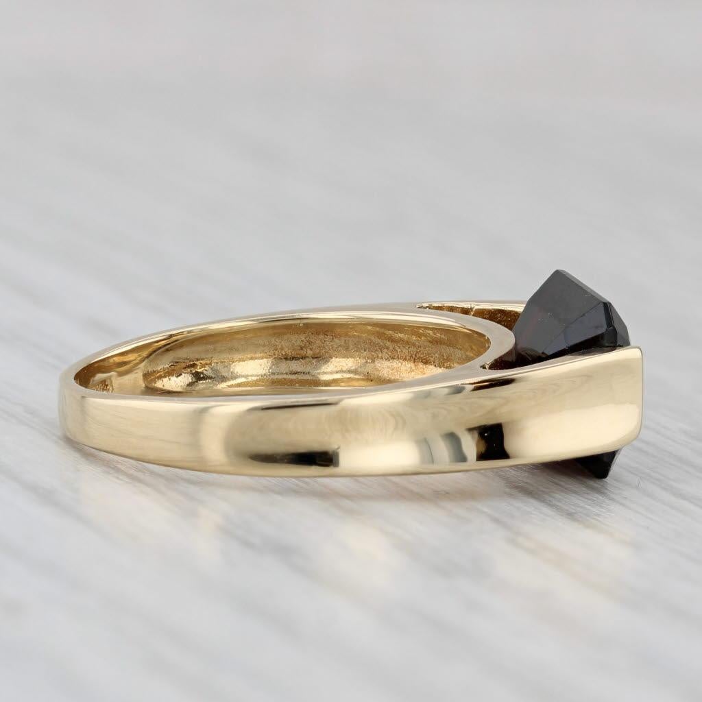 Gemstone Information:
- Natural Garnet -
Carats - 4ct 
Cut - Emerald
Color - Dark Red

Metal: 18k Yellow Gold 
Weight: 5.8 Grams 
Stamps: 750
Face Height: 8 mm 
Rise Above Finger: 6 mm
Band / Shank Width: 2.5 mm

This ring is a size 8 1/4, but it