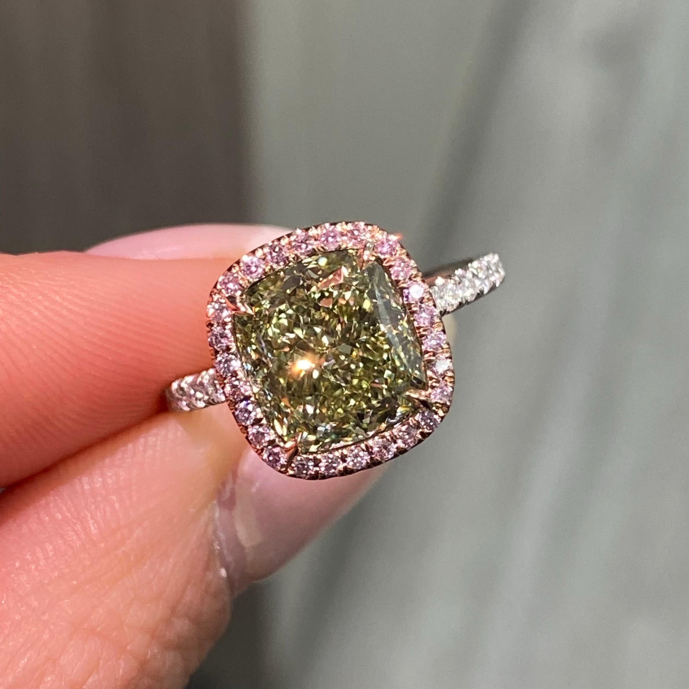 Prepare to be captivated by the radiant beauty of this one-of-a-kind engagement ring, where timeless design meets modern artistry. At its heart lies a stunning 4.02-carat fancy greenish-yellow cushion-cut diamond, glowing with a unique vibrancy that