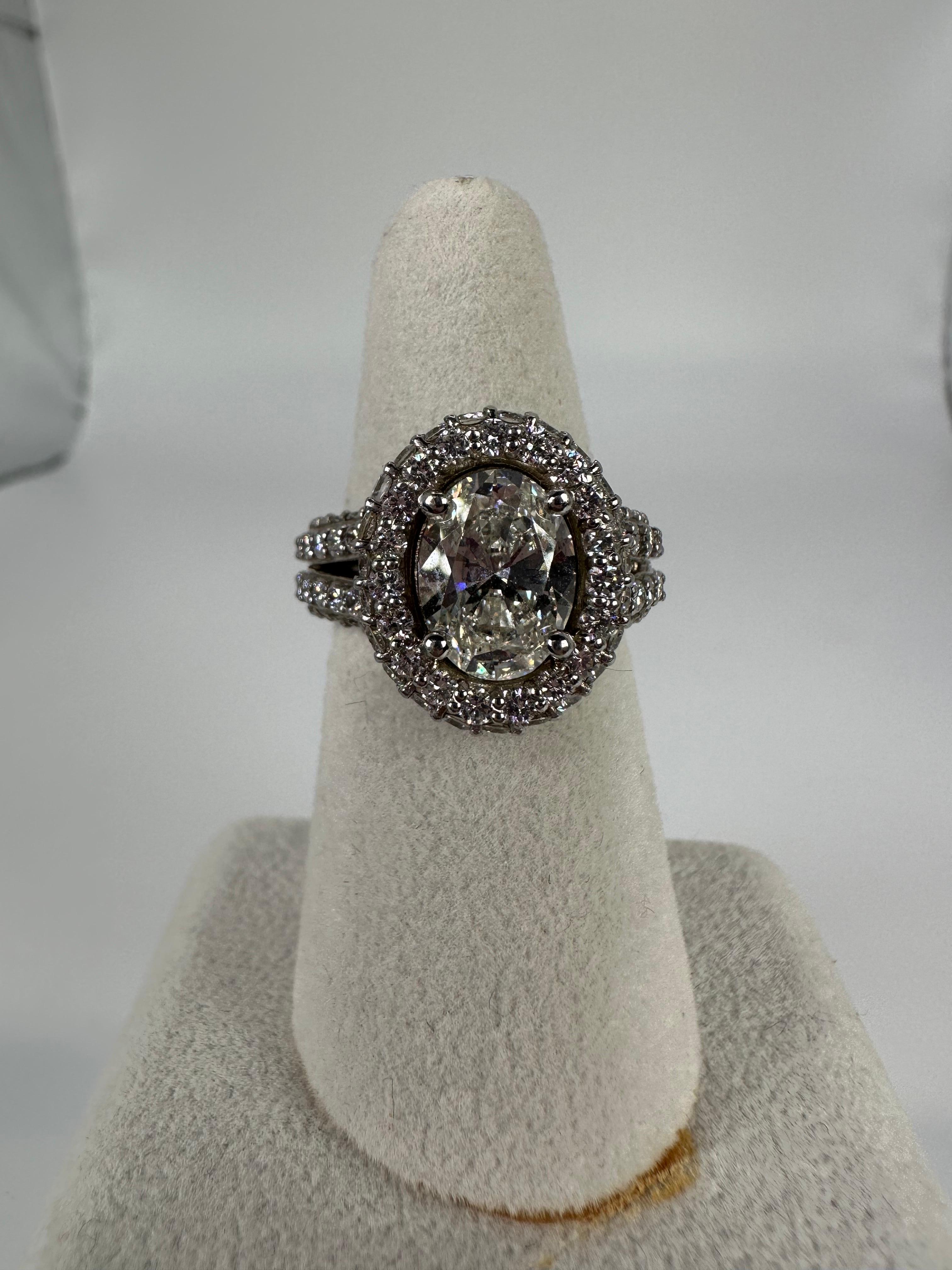 A very unique diamond & moissanite engagement ring, made with 2ct center moissanite and 2.18 carats of natural diamonds in pave setting all througout the ring, made in 14 Karat White gold with impeccable craftsmanship. This type of ring takes over 6