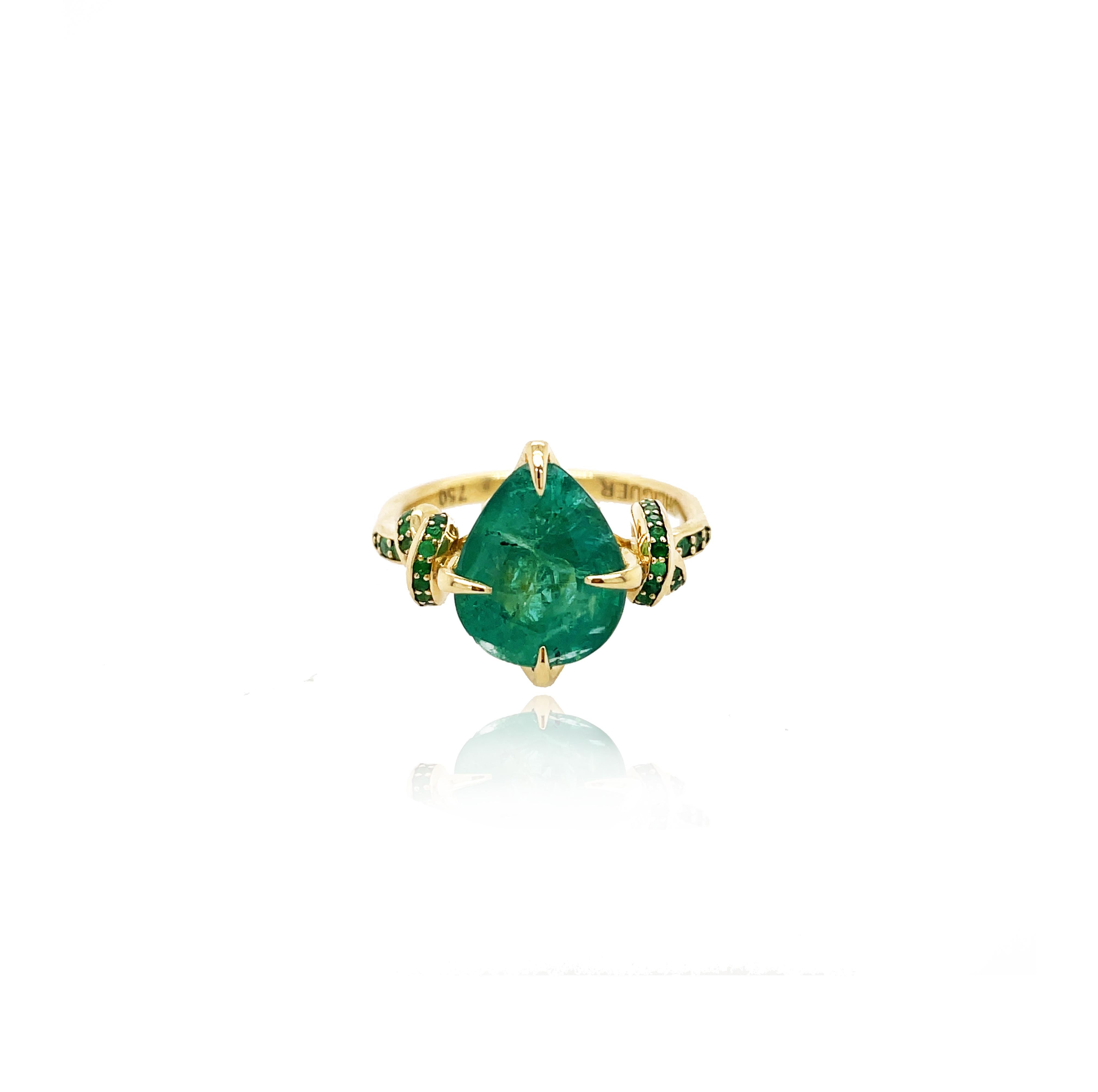 
Glamorously bold and unabashedly seductive. This showstopper one of a kind ring features a 4ct natural pear cut Emerald poised between sharp eagle style talons and embraced by powerful-gold, emerald encrusted ropes, converging to two knots on
