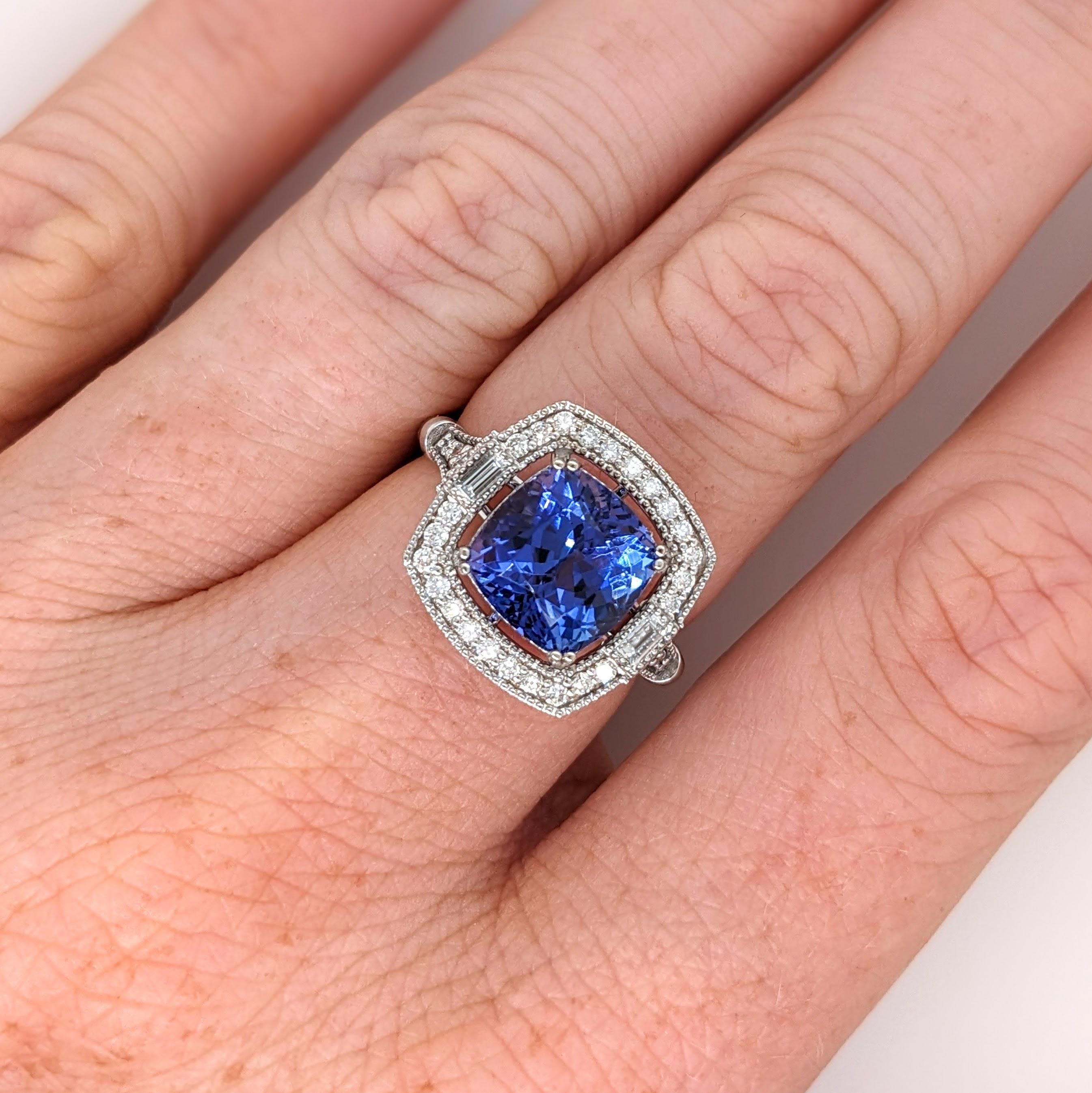 This beautiful ring features a 3.99 carat cushion cut Tanzanite gemstone with natural earth mined diamonds and milgrain detail, all set in solid 14K gold. This Tanzanite ring makes a lovely December birthstone gift for your loved ones!