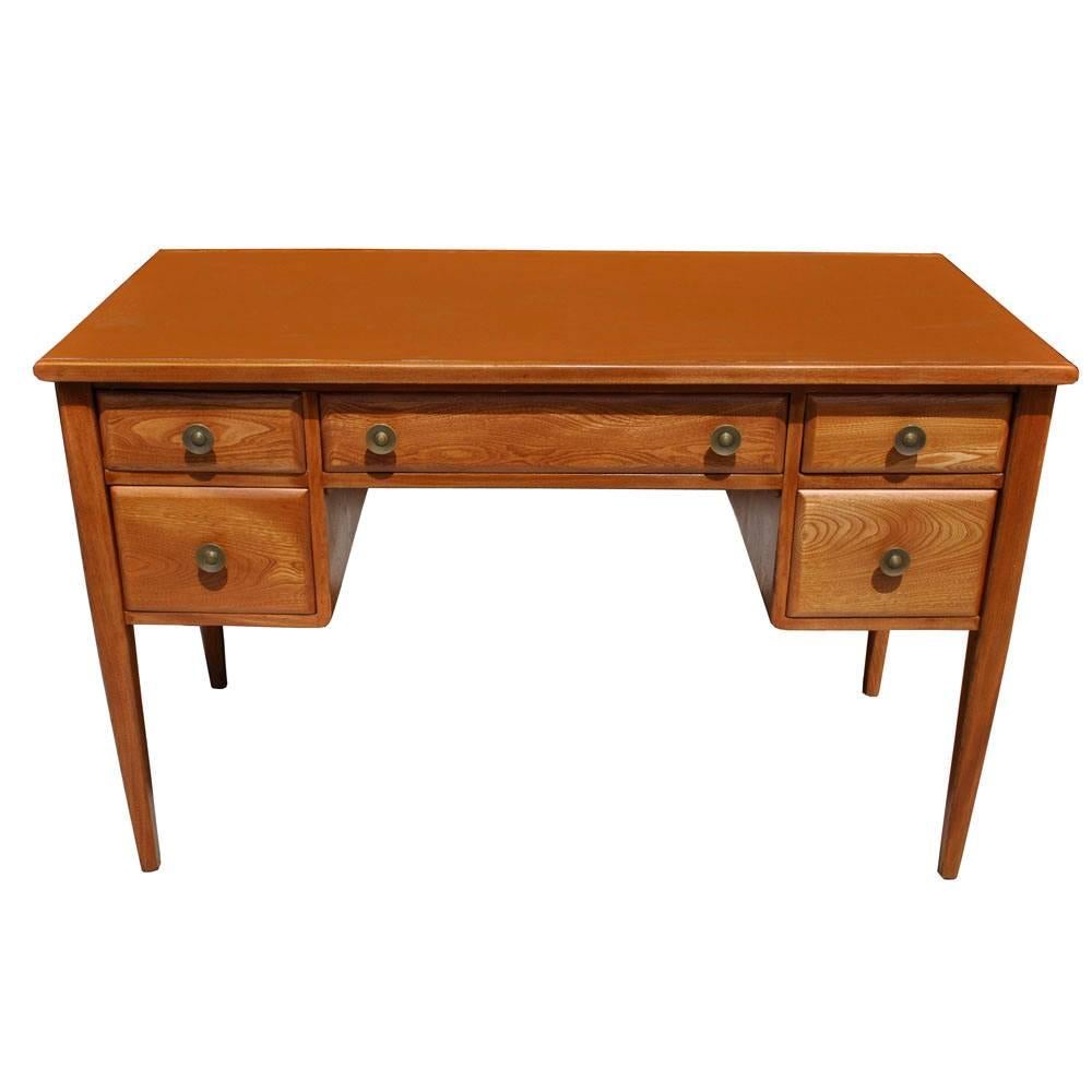 Widdicomb
 

Vintage midcentury desk by Widdicomb 
 
Oak with caramel Naugahyde top.
The finished back allows for flexible placement in room.
Tapered legs with five drawers and bronze pulls.