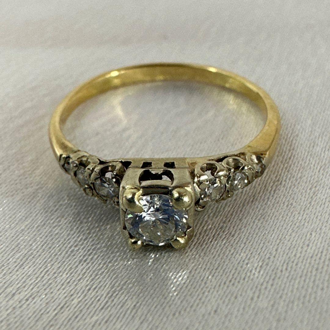 Immerse yourself in the enchanting realm of antique jewelry with this captivating cocktail diamond ring, meticulously crafted in 14k yellow gold with white gold accents. A true embodiment of timeless elegance, this piece seamlessly marries vintage