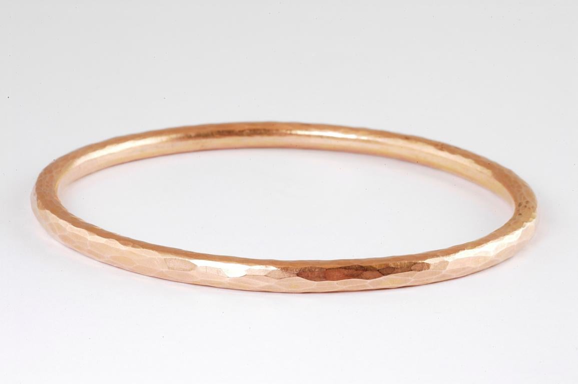 4mm 18ct rose gold hammered bangle with channel set brilliant cut diamonds handmade in Notting Hill London by renowned British jewellery designer Malcolm Betts.
The Channel set brilliant cut diamonds stand out against the backdrop of the beaten 18ct