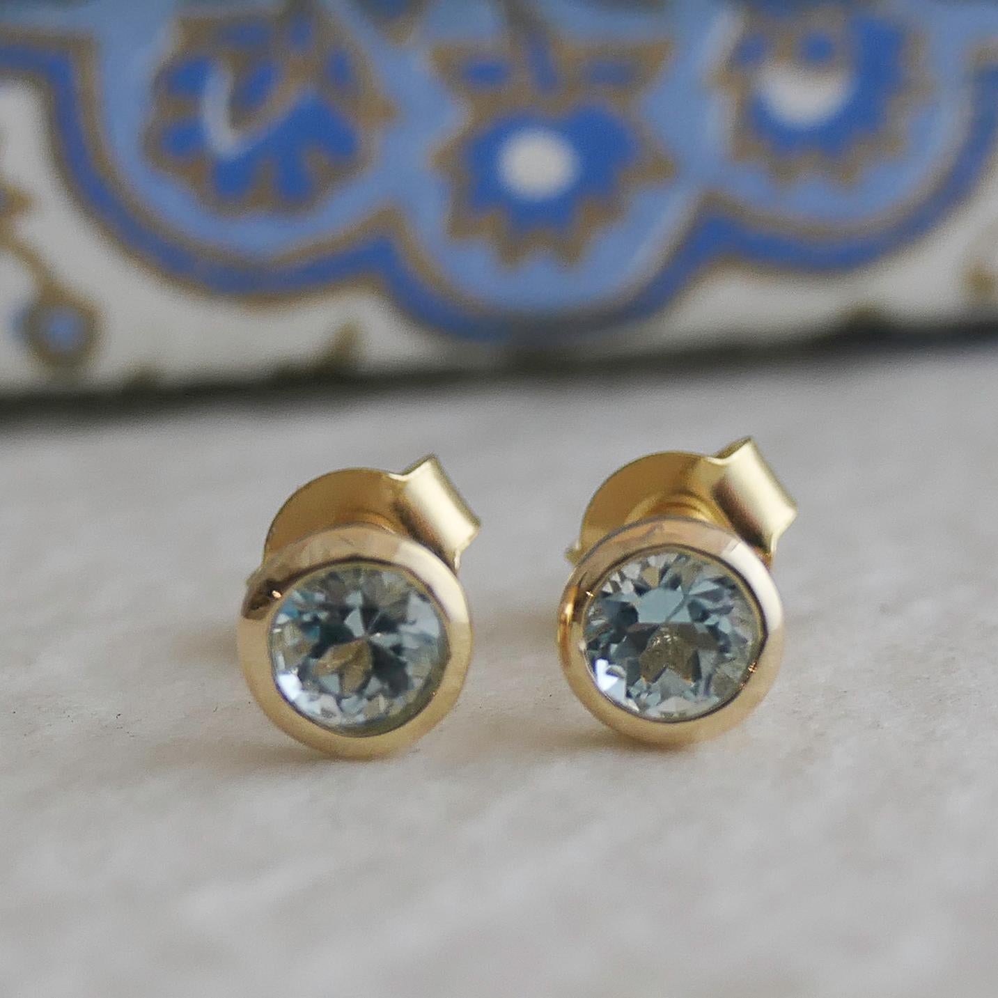 4mm faceted round blue topaz is set in gold plated sterling silver. Diameter for earrings are approximately 5mm. 