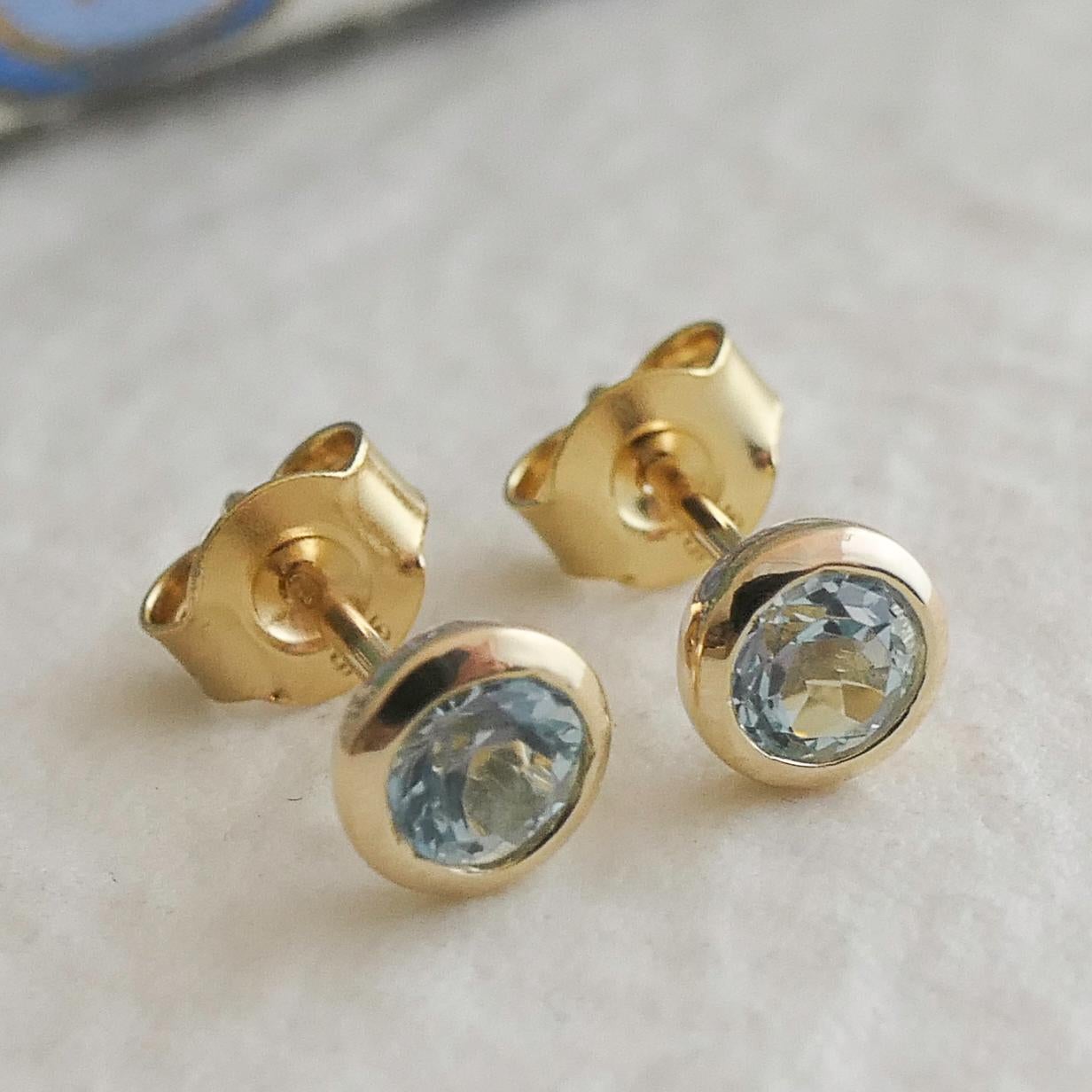 Round Cut 4mm Blue Topaz Gold Plated Sterling Silver Stud Earrings For Sale