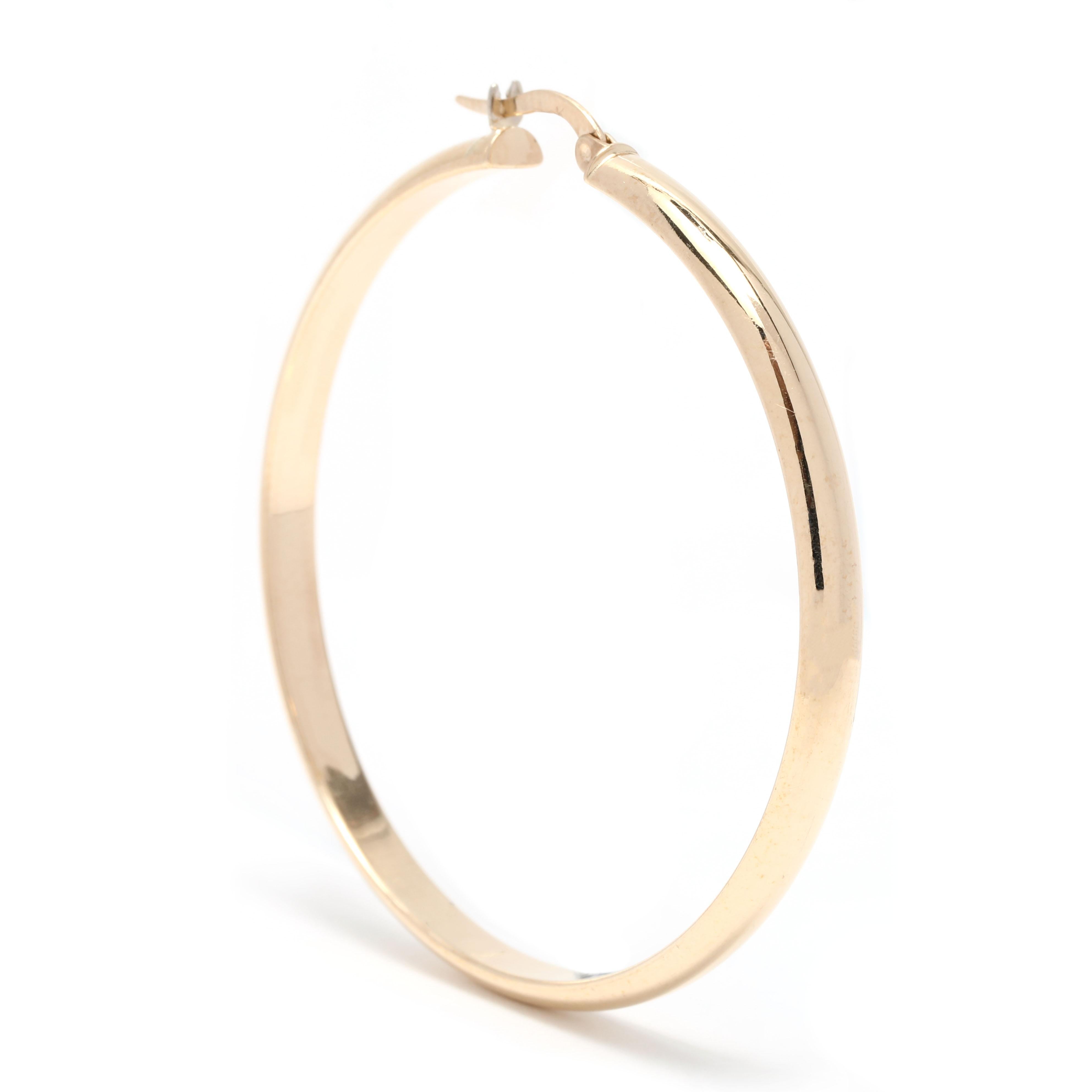 These classic, yet stylish 4mm Large Gold Thin Hoop Earrings are perfect for everyday wear. These earrings are crafted from 14K Yellow Gold and measure 2 inches in length, making them the perfect size for everyday wear. With their large skinny gold