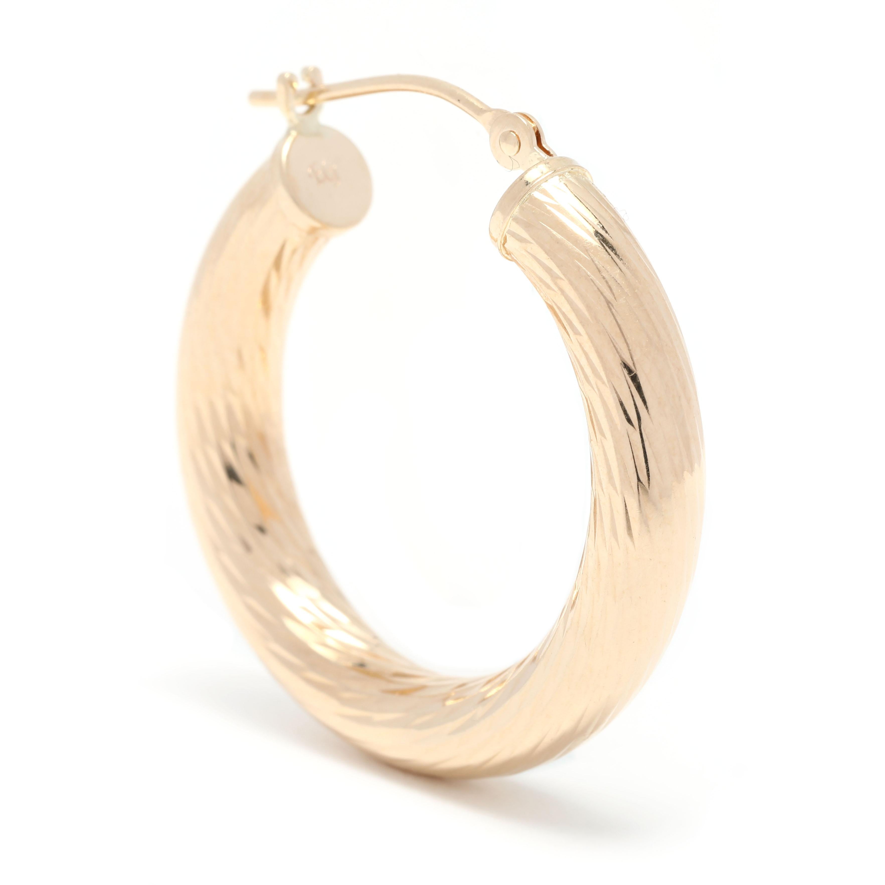 Look great in any moment with these 14K yellow gold medium twist hoop earrings. The perfect accessory for any outfit, these timeless 4mm gold hoops measure 1 inch in length and feature a simple, classic design. Show off your style with these