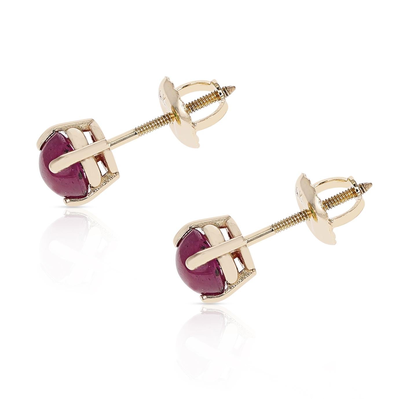 A pair of 4MM Ruby Round Cabochon Stud Earrings made in 14 Karat Yellow Gold. The total stone weight ranges from approximately 0.83 - 1.06 carats.