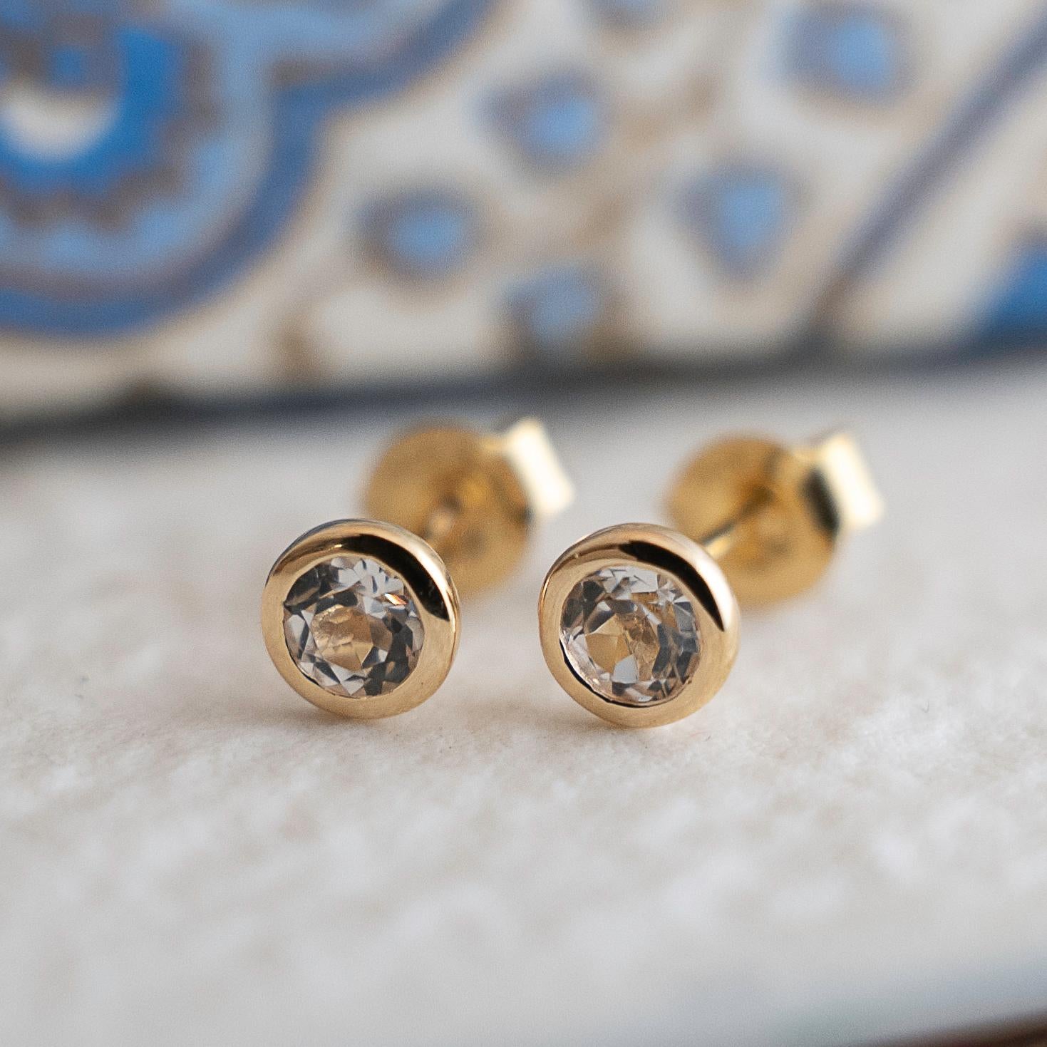 4mm faceted round white topaz is set in gold plated sterling silver. Diameter for earrings are approximately 5mm. 