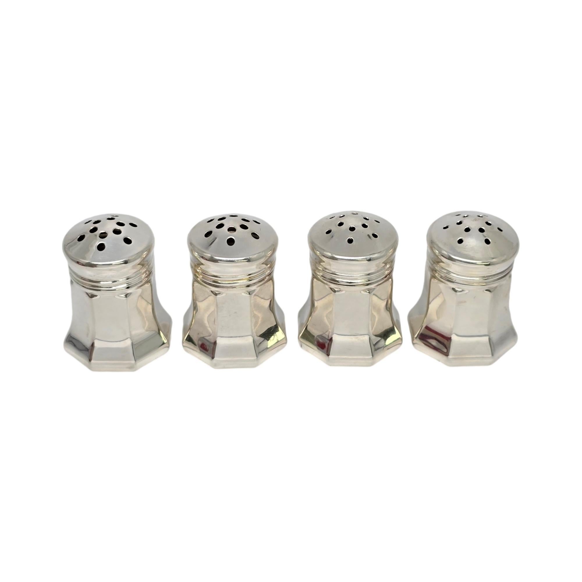 Set of 4 sterling silver salt and pepper shakers by Cartier with box.

This set of 4 includes 2 salt shakers and 2 pepper shakers. The salt shakers feature smaller holes, the pepper shakers feature larger holes. Includes Cartier satin and velvet