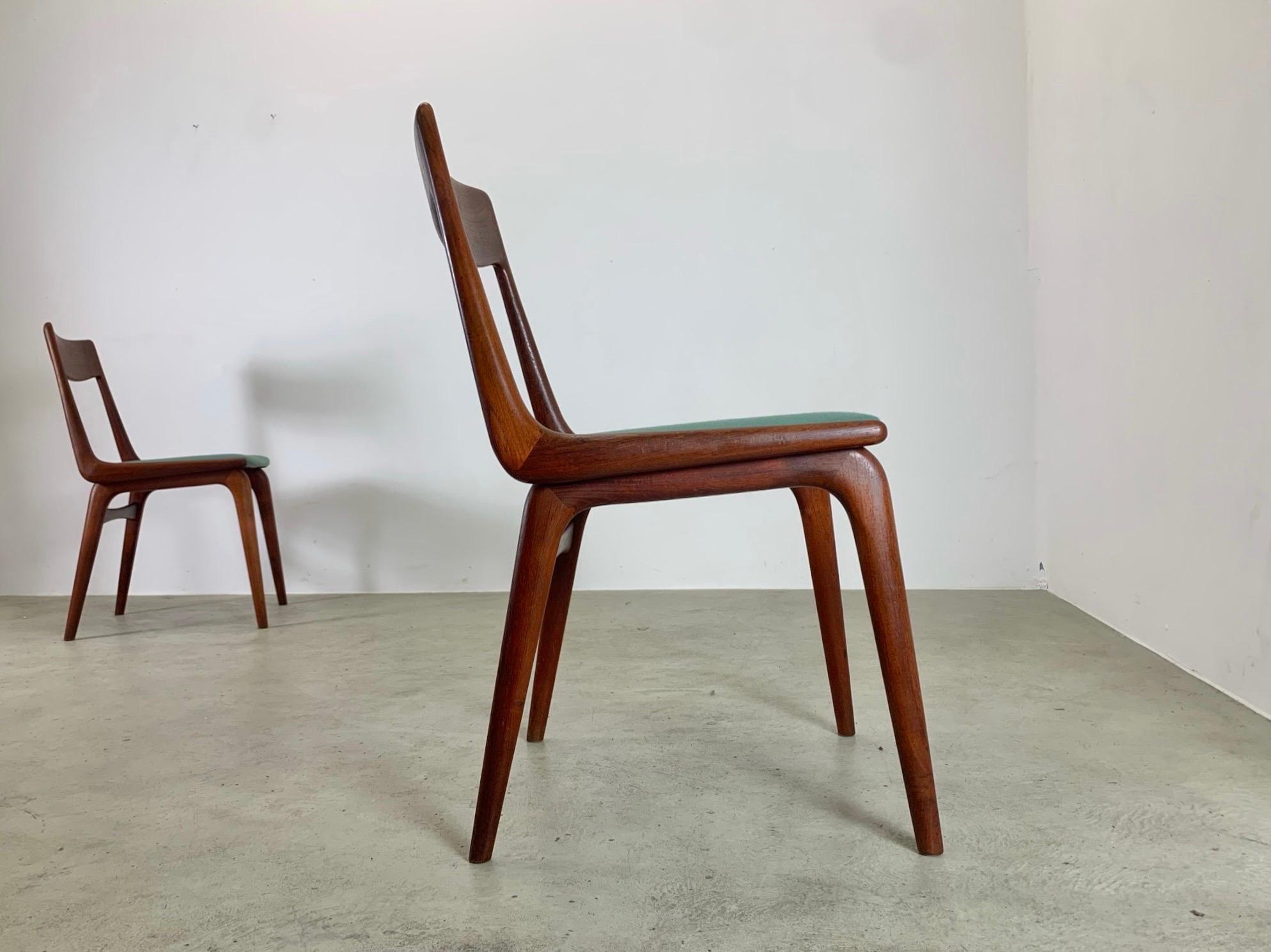 A rare set of four dining chairs by Alfred Christensen
Made in Denmark, during the 1950s by Slagelse Møbelværk.
They feature a boomerang shape with an organic back rest and legs made of 
solid teak wood. This is a minimalist and classic Danish