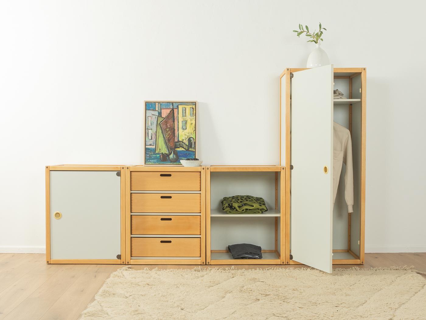 Four-part Profilsystem by Flötotto from the 1970s. The system consists of one high container with door, shelf and a clothes rail, one container with four drawers, an open container with shelf and one container with door and shelf. Frame and drawers