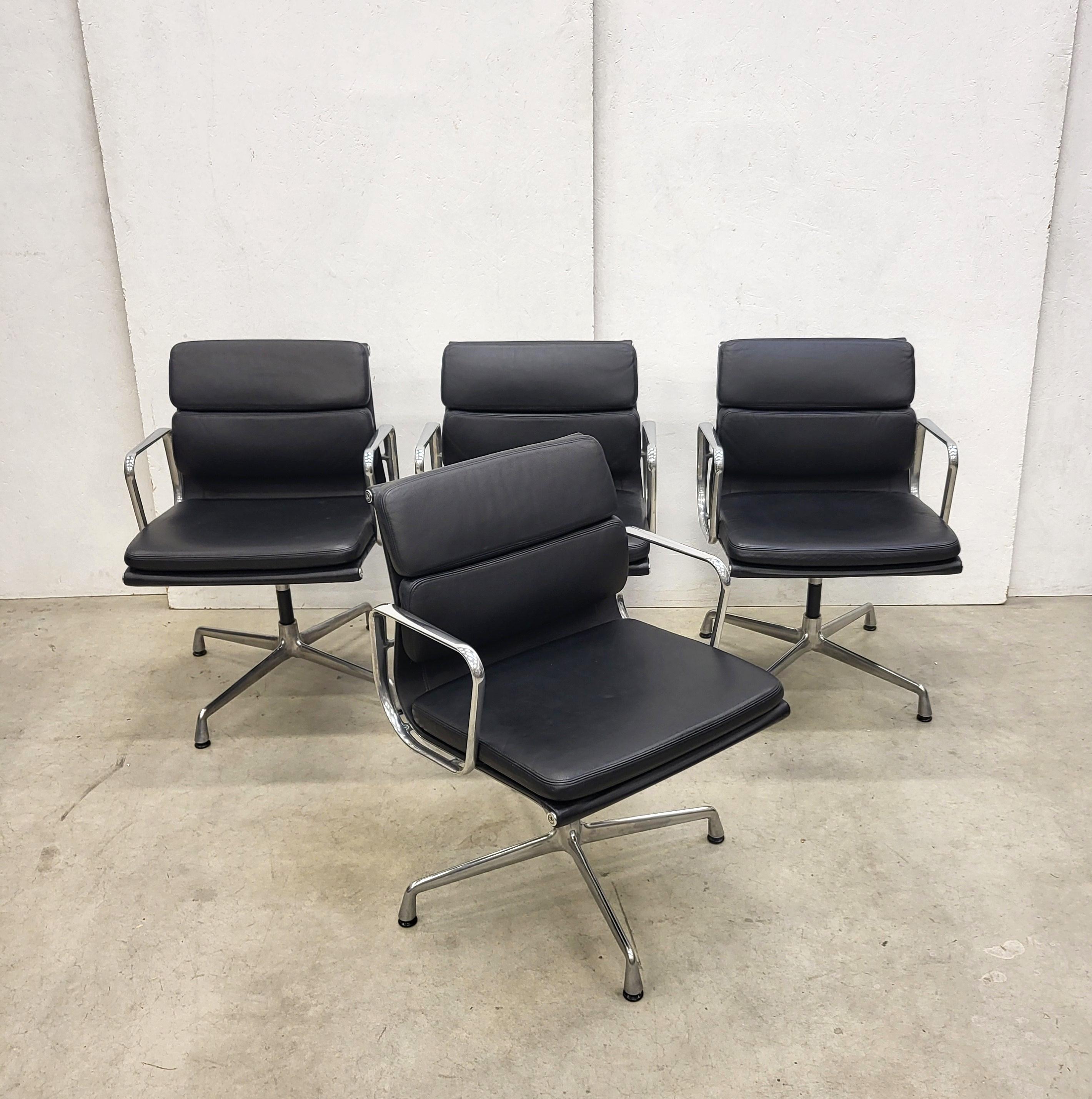 Very nice set of 4 soft pad office chairs model EA208 produced by Vitra. 
The chairs features a polished aluminium frame and were made in 2006.

They features a wonderful black leather upholstery and the back is covered with black fabric.

The
