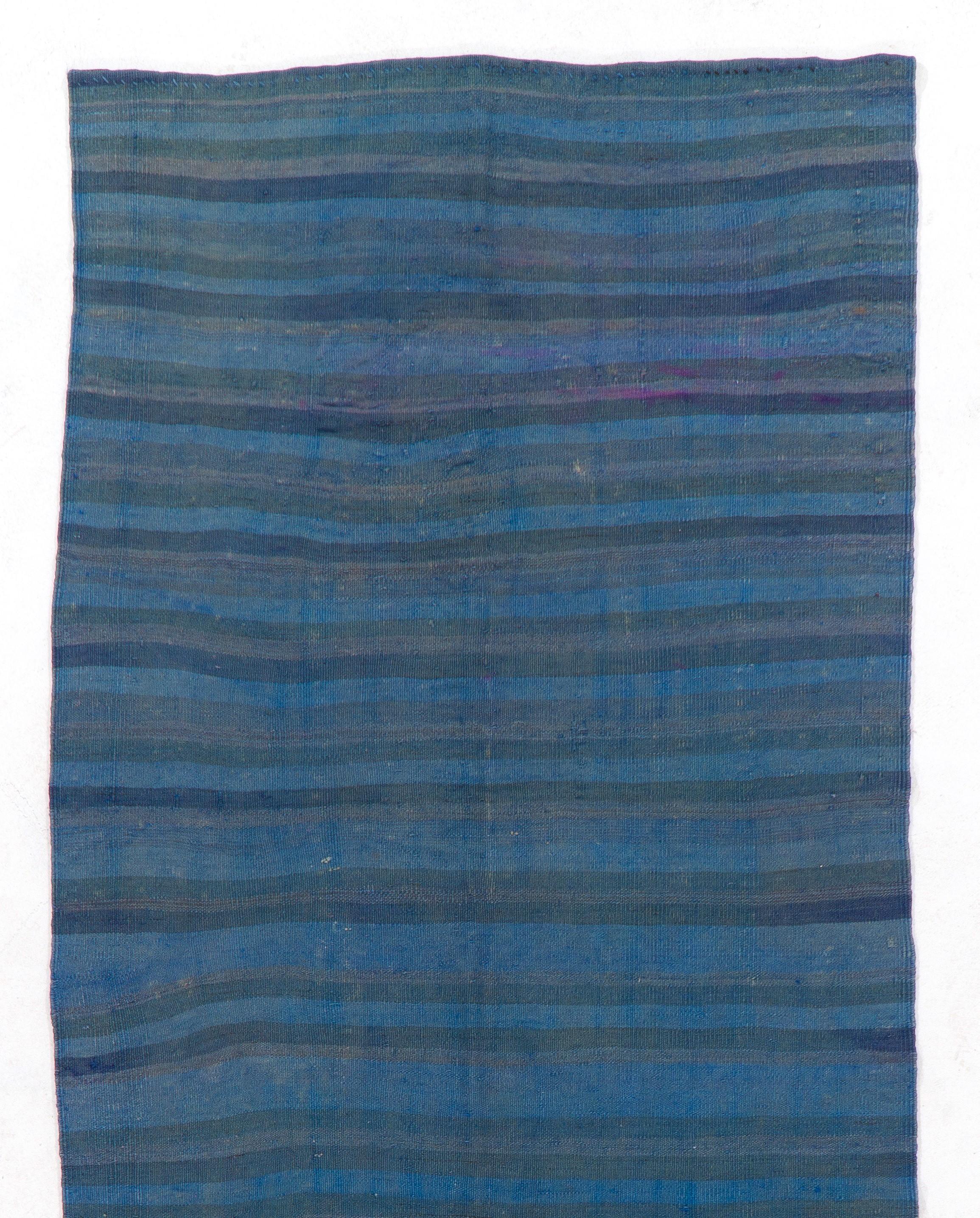 A vintage Turkish flat-woven runner rug made of wool, with a banded design over-dyed in blue.

We can modify the dimensions if requested, ie. make it shorter and/or narrower. 

Reversible; both sides can bu used.

Ideal for both residential and