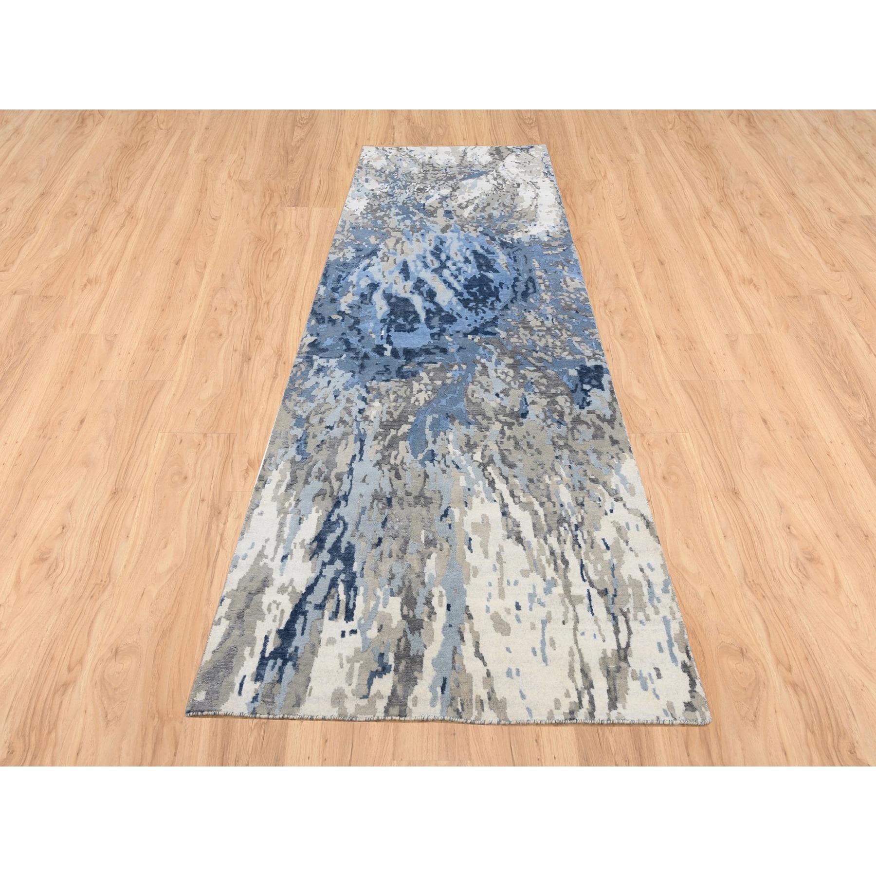 This is a truly genuine one-of-a-kind Ivory Abstract Design Hi-low Pile Wool and Plant Based Silk Hand Knotted Oriental Wide Runner Rug. It has been Knotted for months and months in the centuries-old weaving craftsmanship techniques by expert