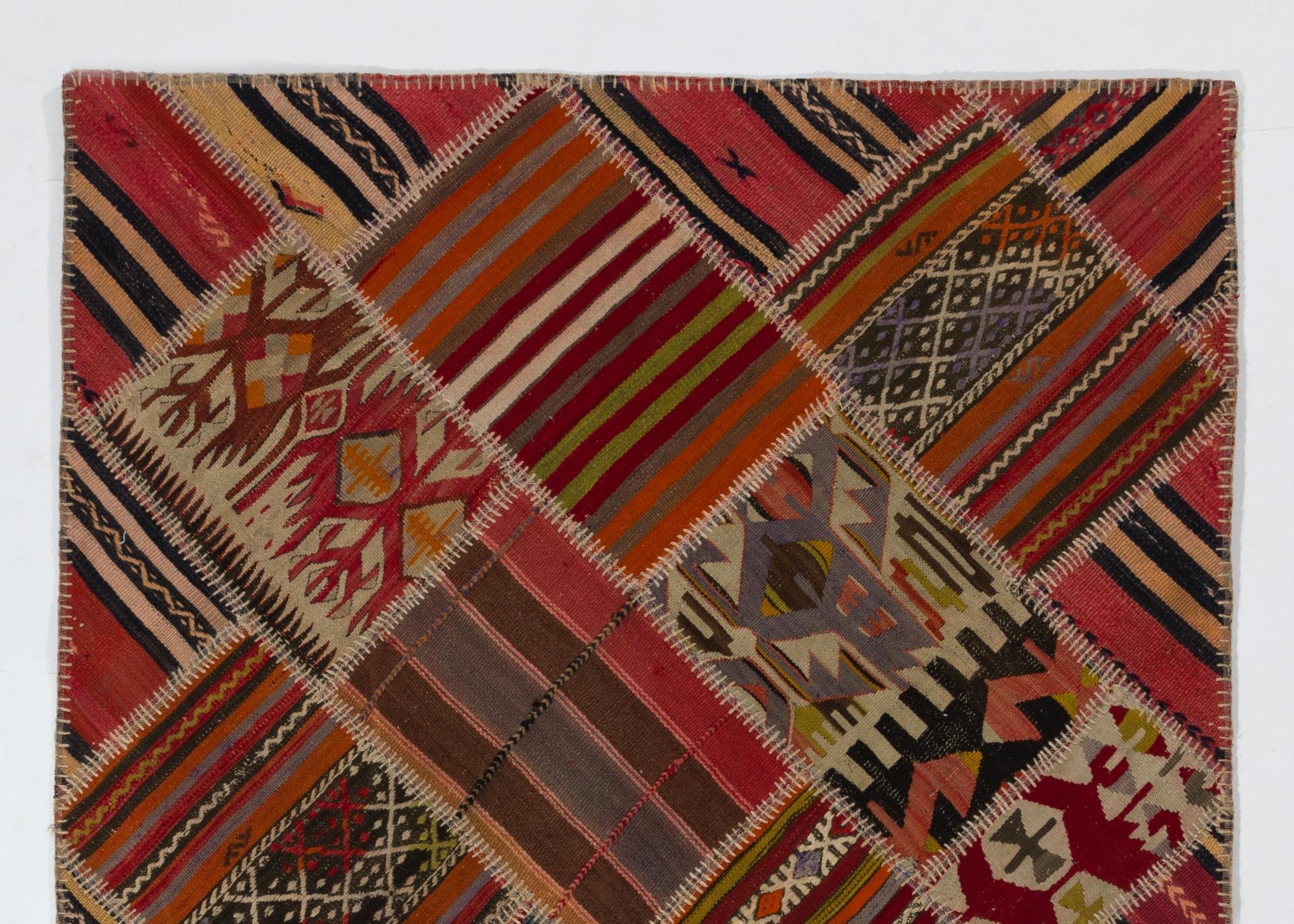 A colorful, cheerful Turkish Kilim rug (flat-weave) hand-stitched from pieces of hand-woven Turkish Kilim. It features an assortment of patches in vivid colors with a variety classical Kilim motifs that help create high visual interest. 

The Kilim